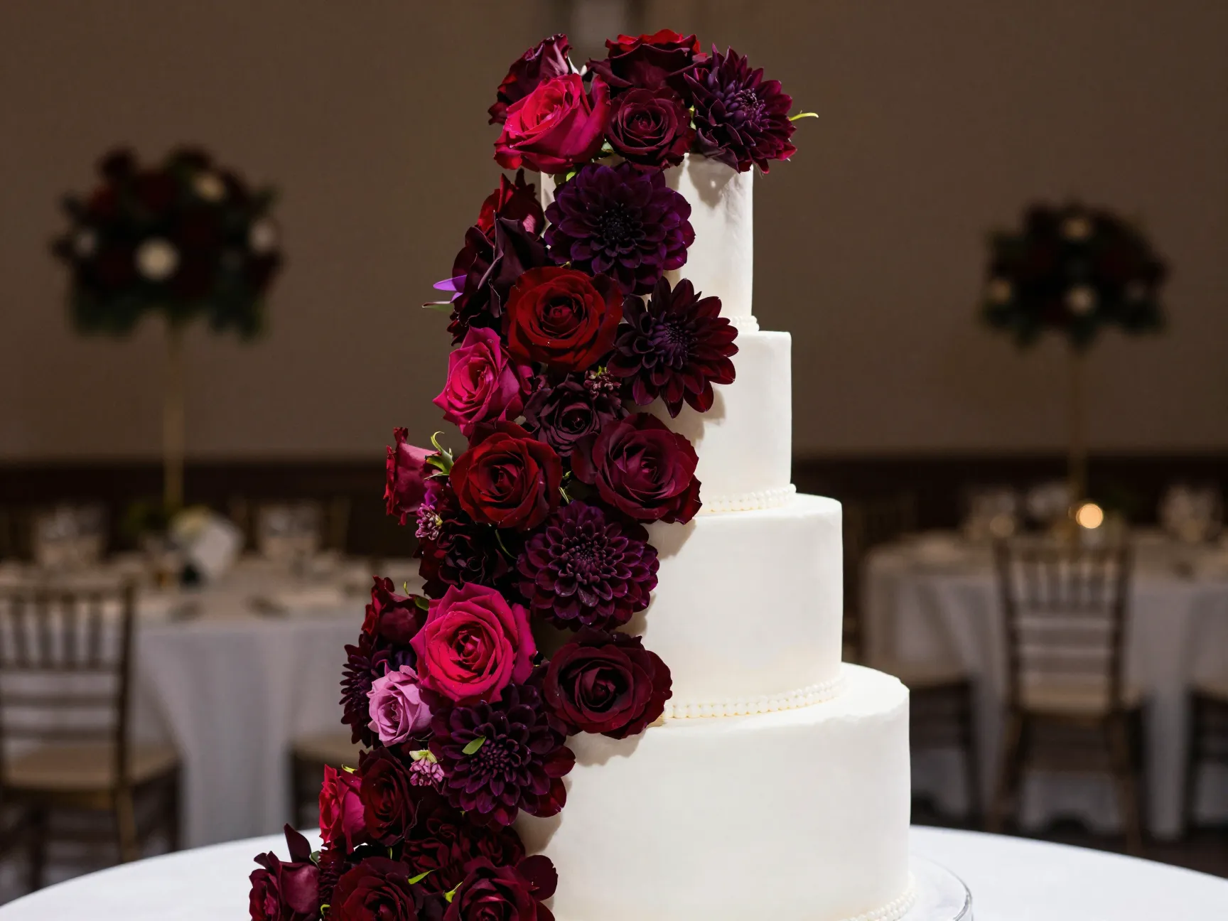 Bold statement floral two tier cake with deep burgundy cascade