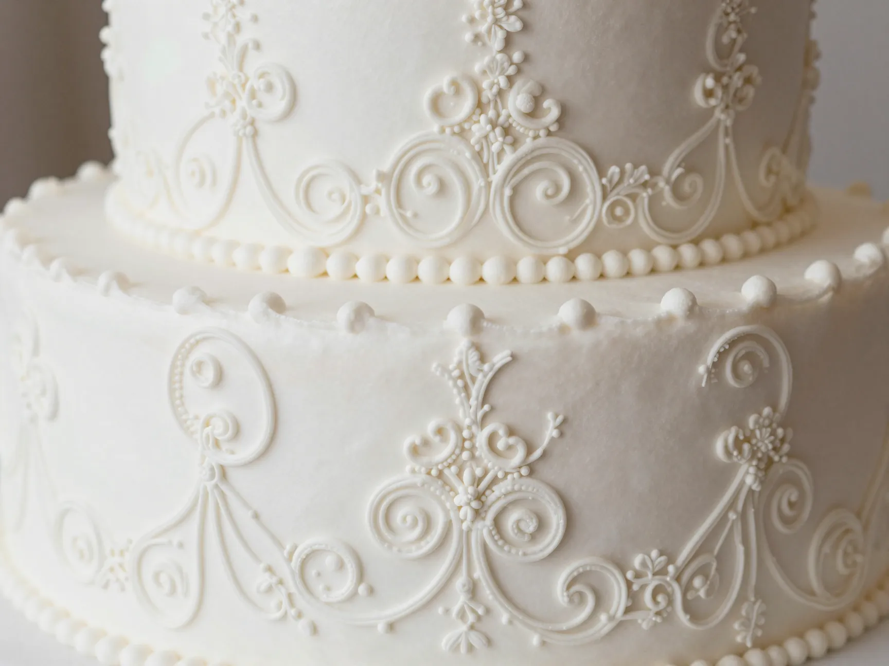Royal icing lacework cake with intricate filigree and scroll patterns