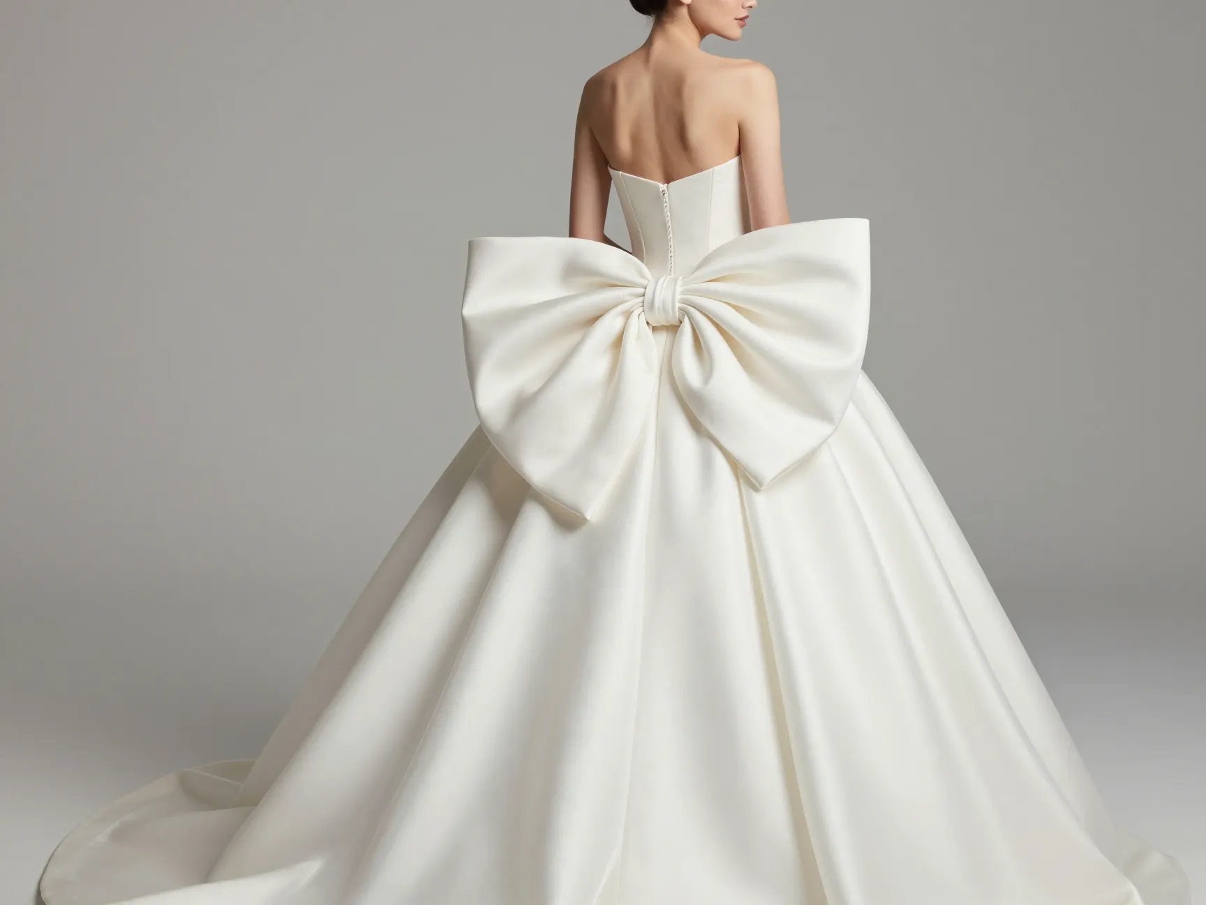 Statement bow ballgown with oversized architectural back bow