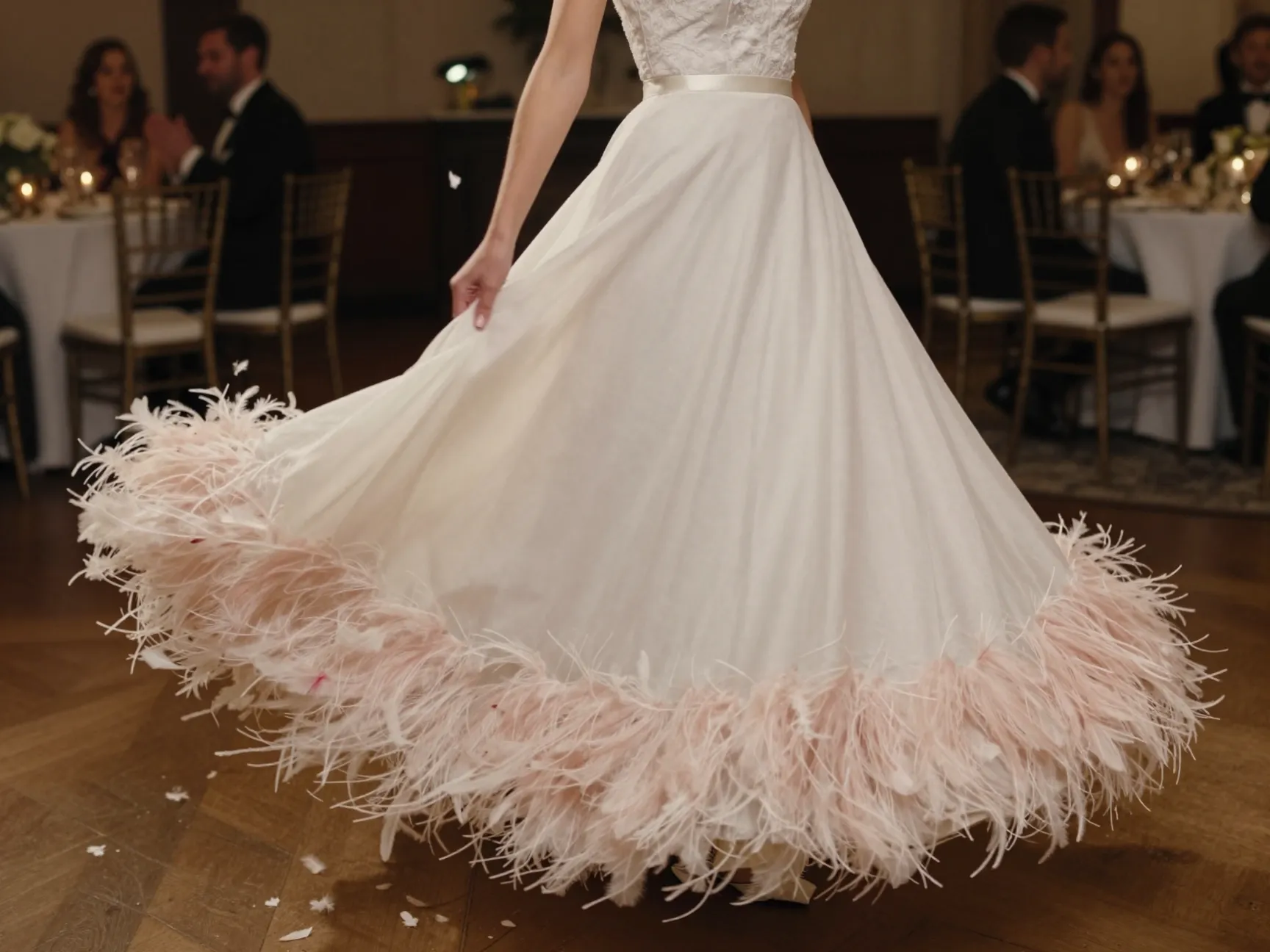 Drop waist gown with feather trim on the flowing skirt hem