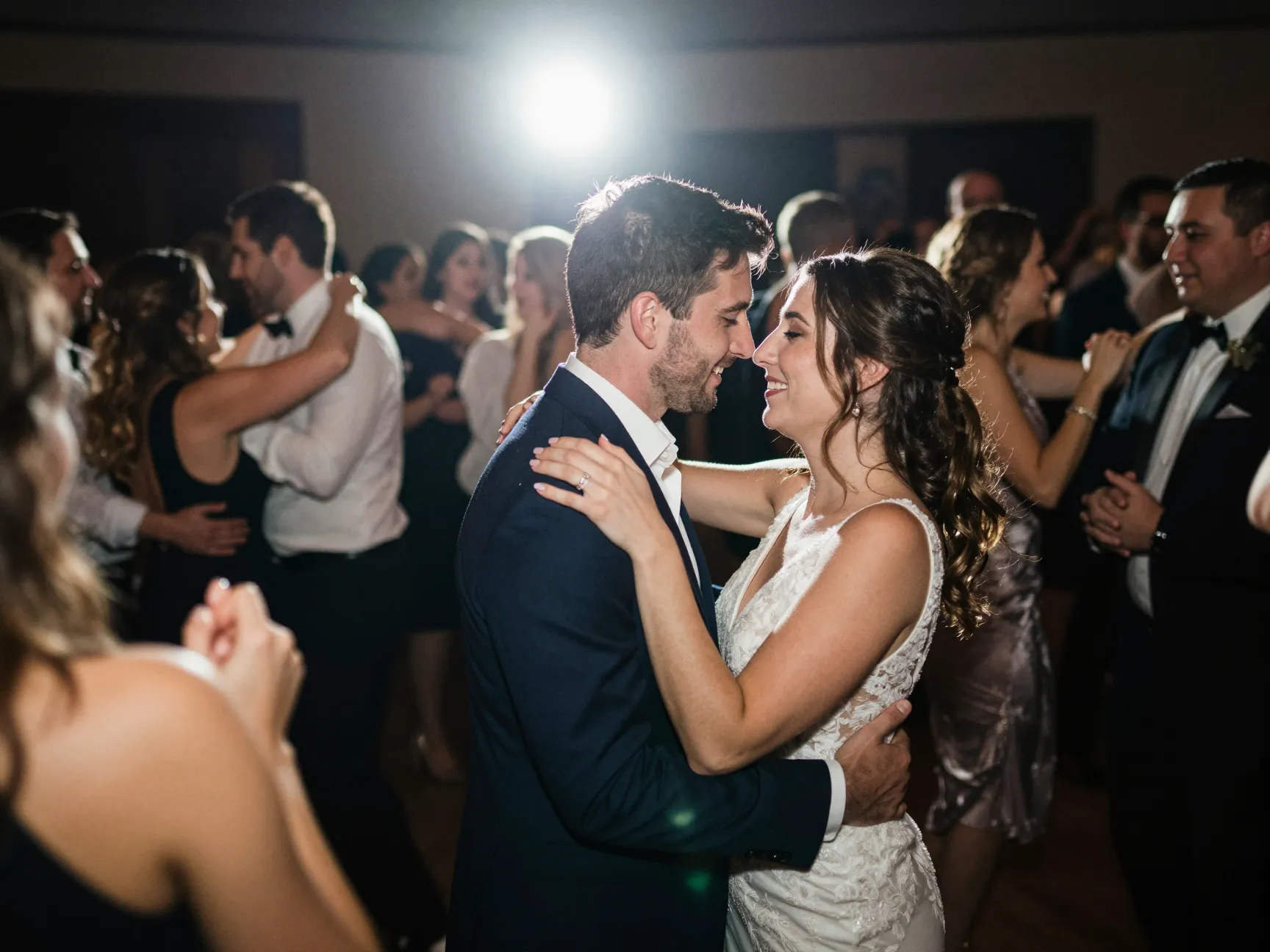 Direct flash photograph of couple celebrating on crowded dance floor