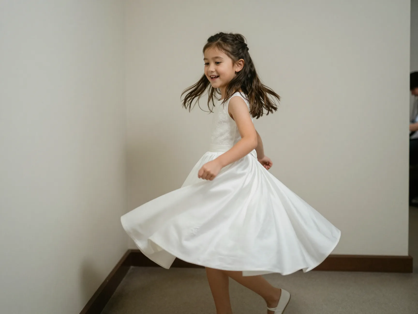 Candid documentary photo of flower girl spinning in her dress unnoticed