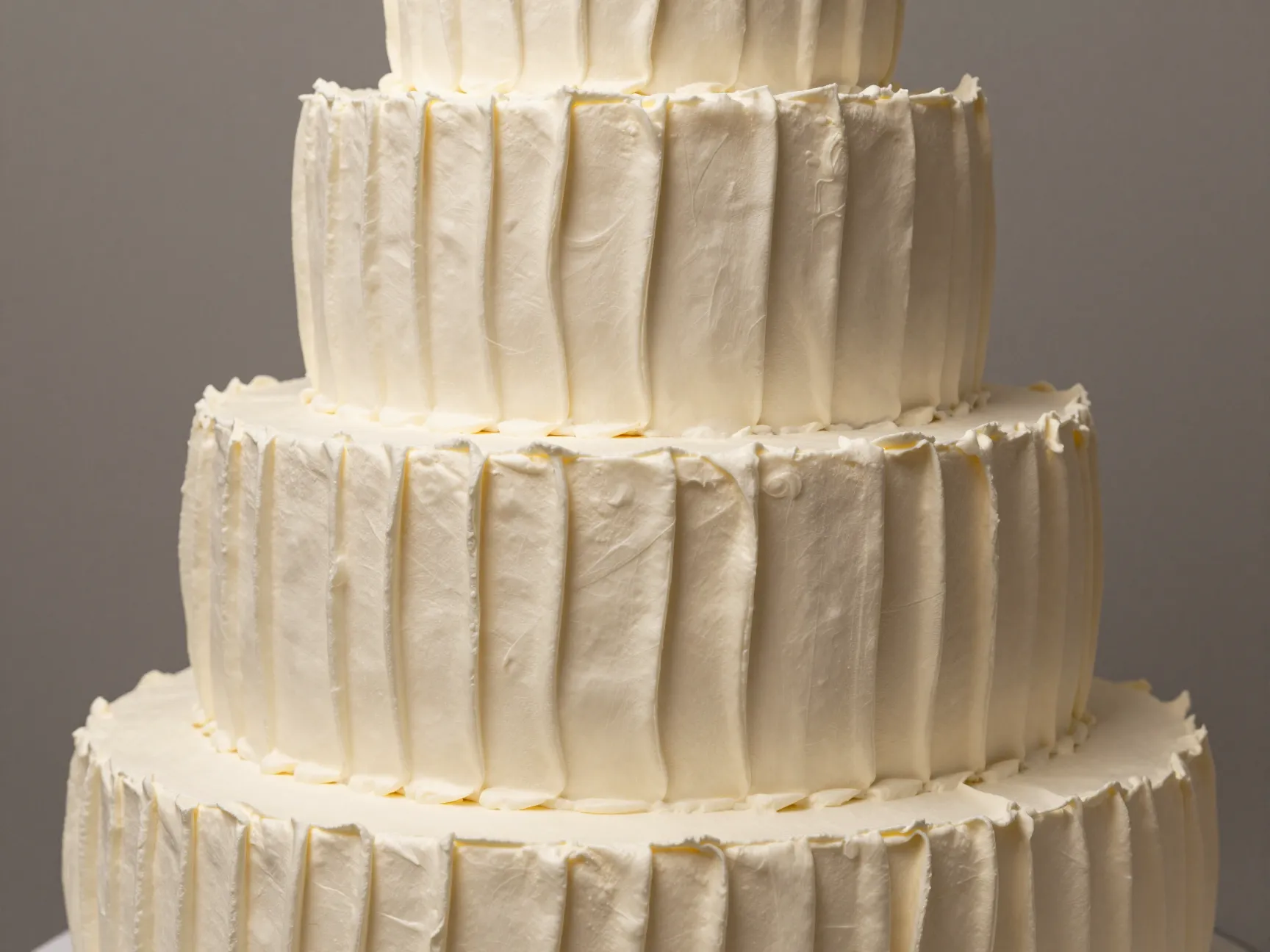 Pleated buttercream wedding cake with sculptural textured finish