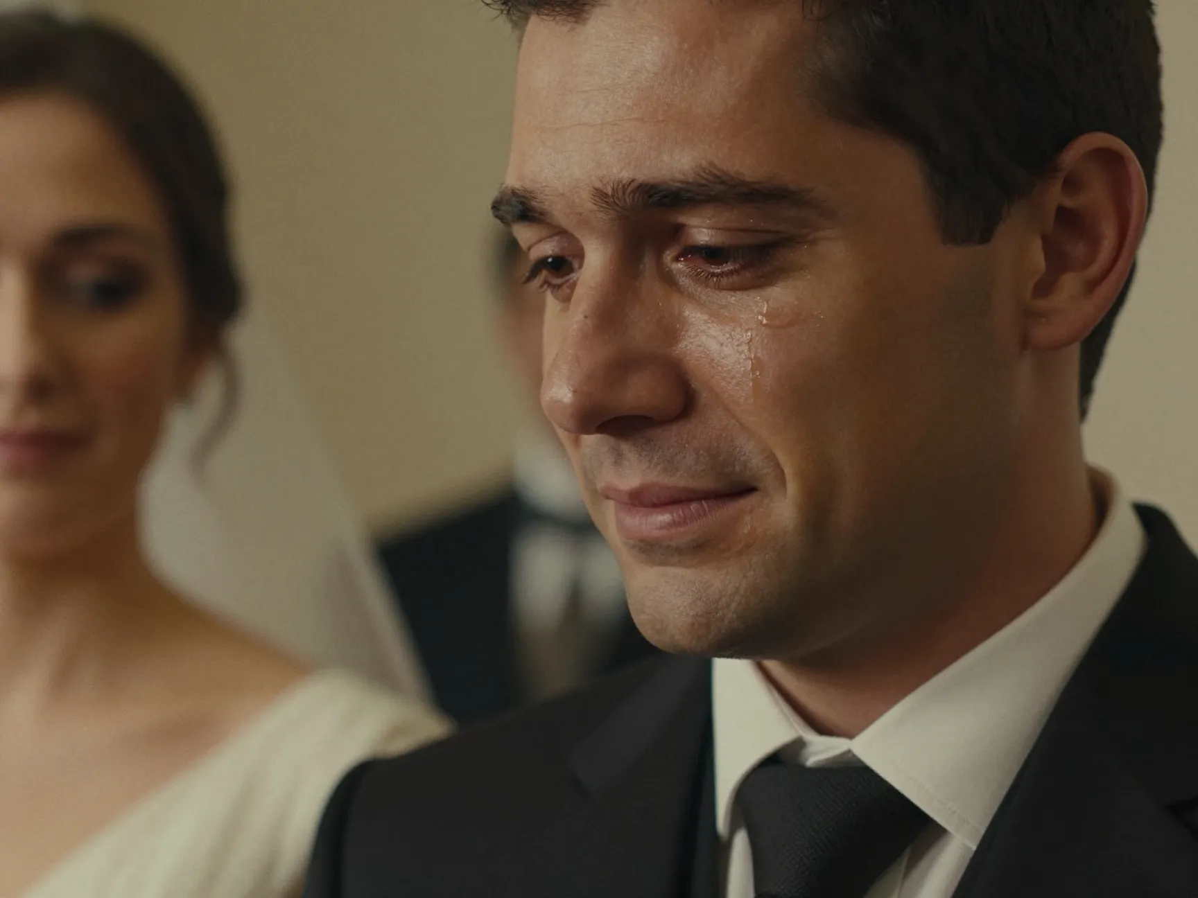 Film photograph of emotional groom watching bride walk down aisle