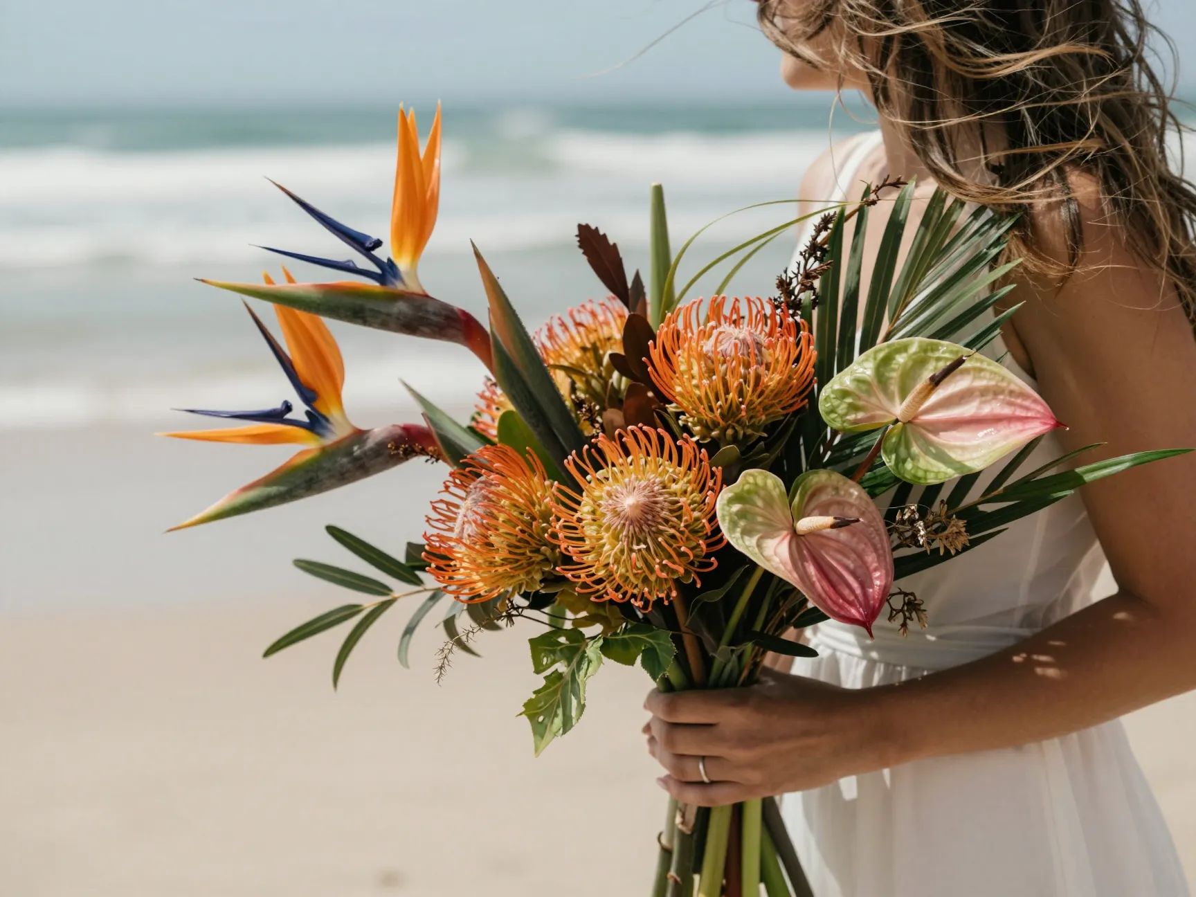 Loose garden style bouquet with tropical blooms beach