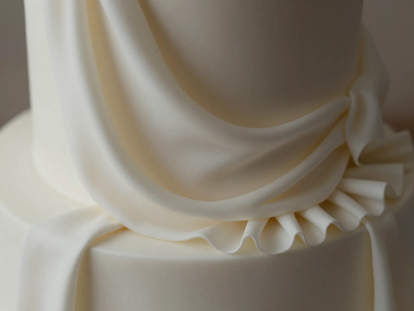 Fabric draped fondant cake with elegant silk ruffles