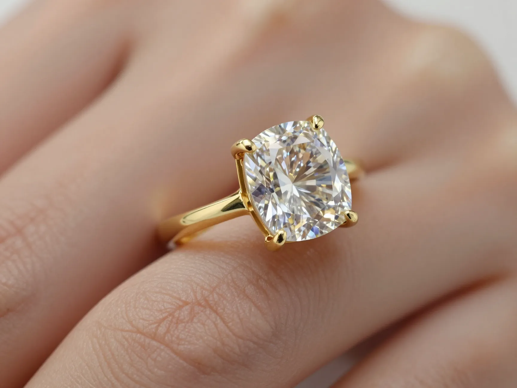 East west oriented cushion cut diamond in yellow gold setting