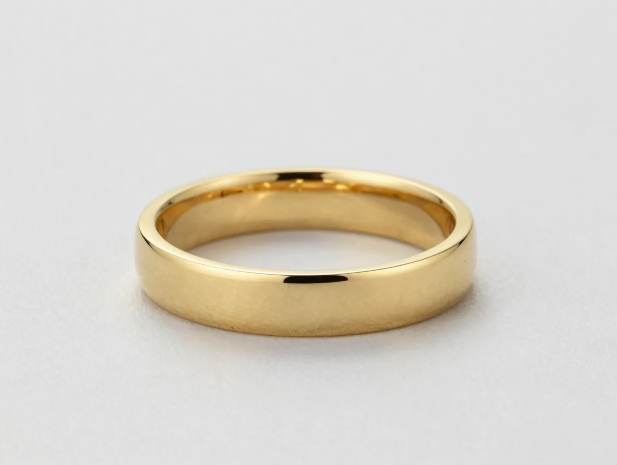 Sculptural wide knife edge band in high polish yellow gold