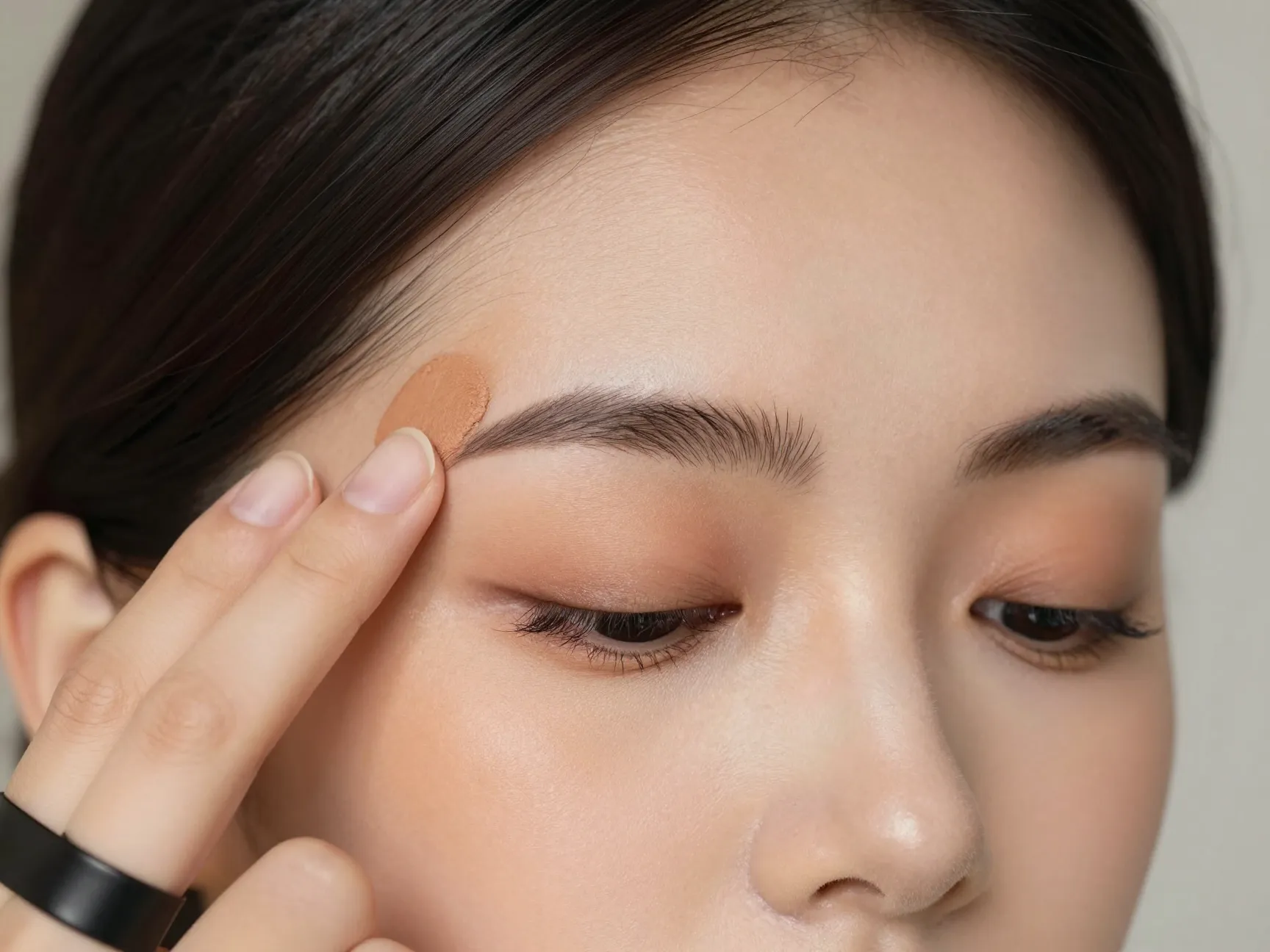 Bride blending cream bronzer for soft sculpting along temples