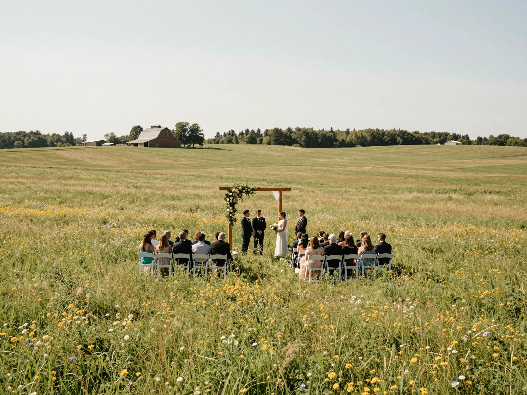 Expansive farm wedding ceremony in a wildflower meadow on a vast property