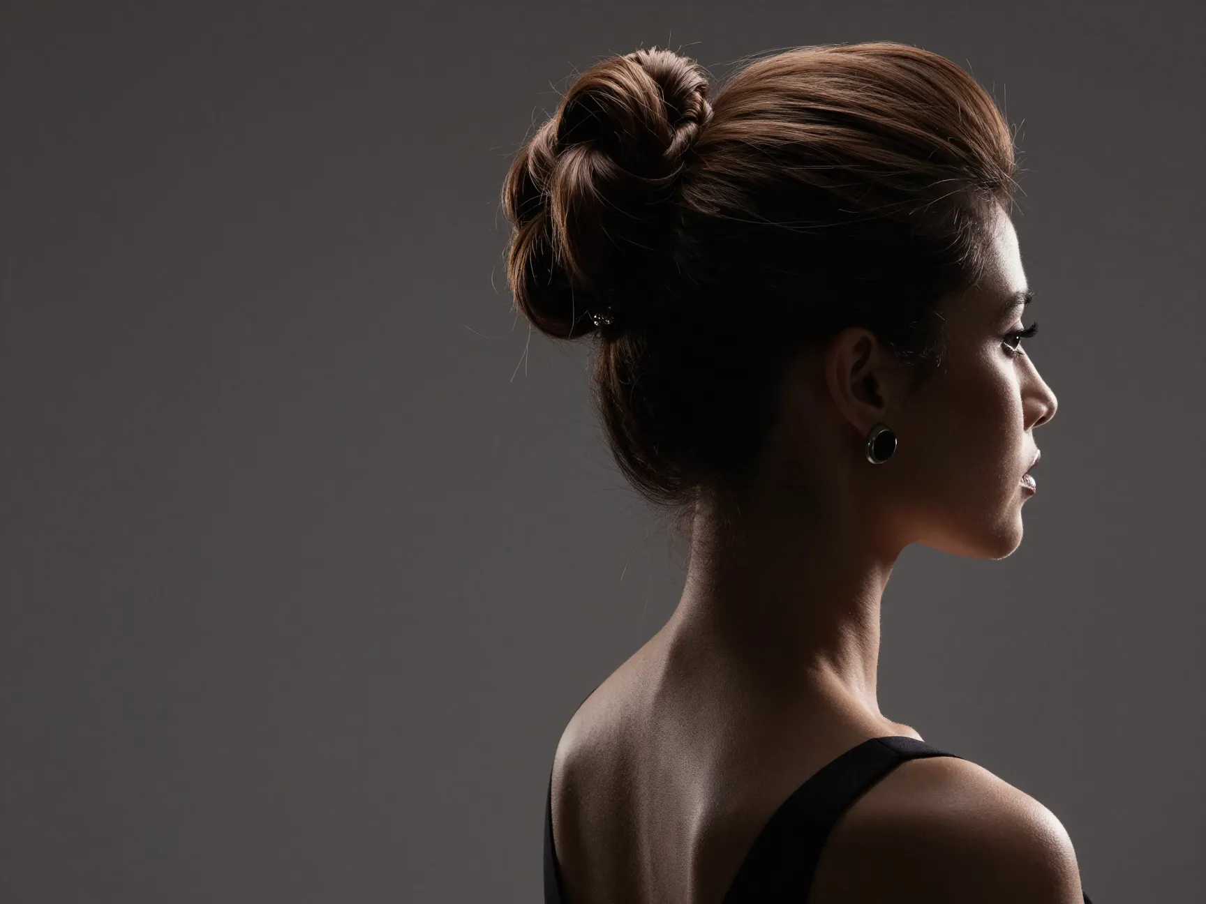 Bride with high swept twist hairstyle striking profile view