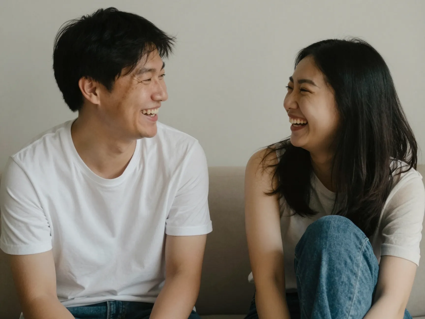 A camera shy couple laughing together in a private studio