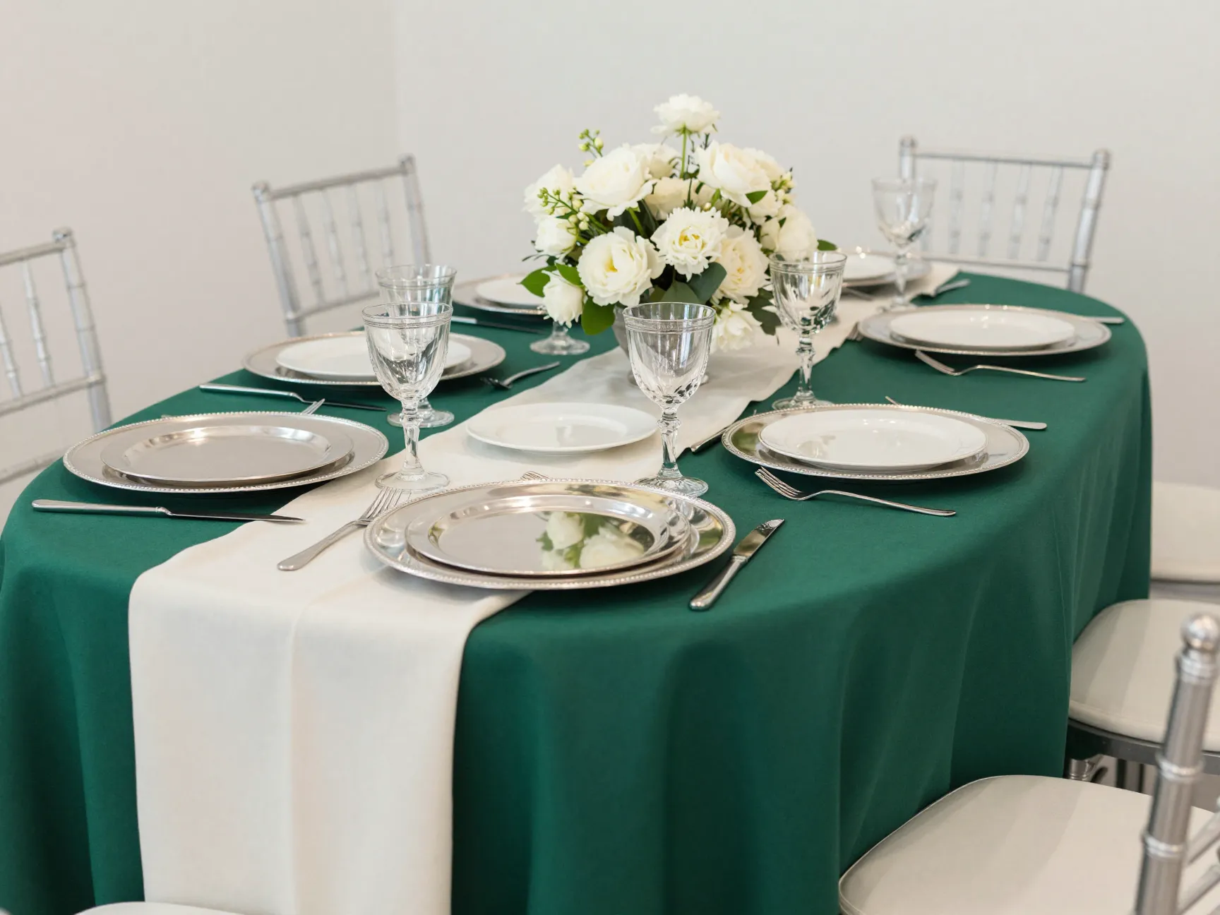 Bold jewel tone wedding table with emerald linens and silver accents
