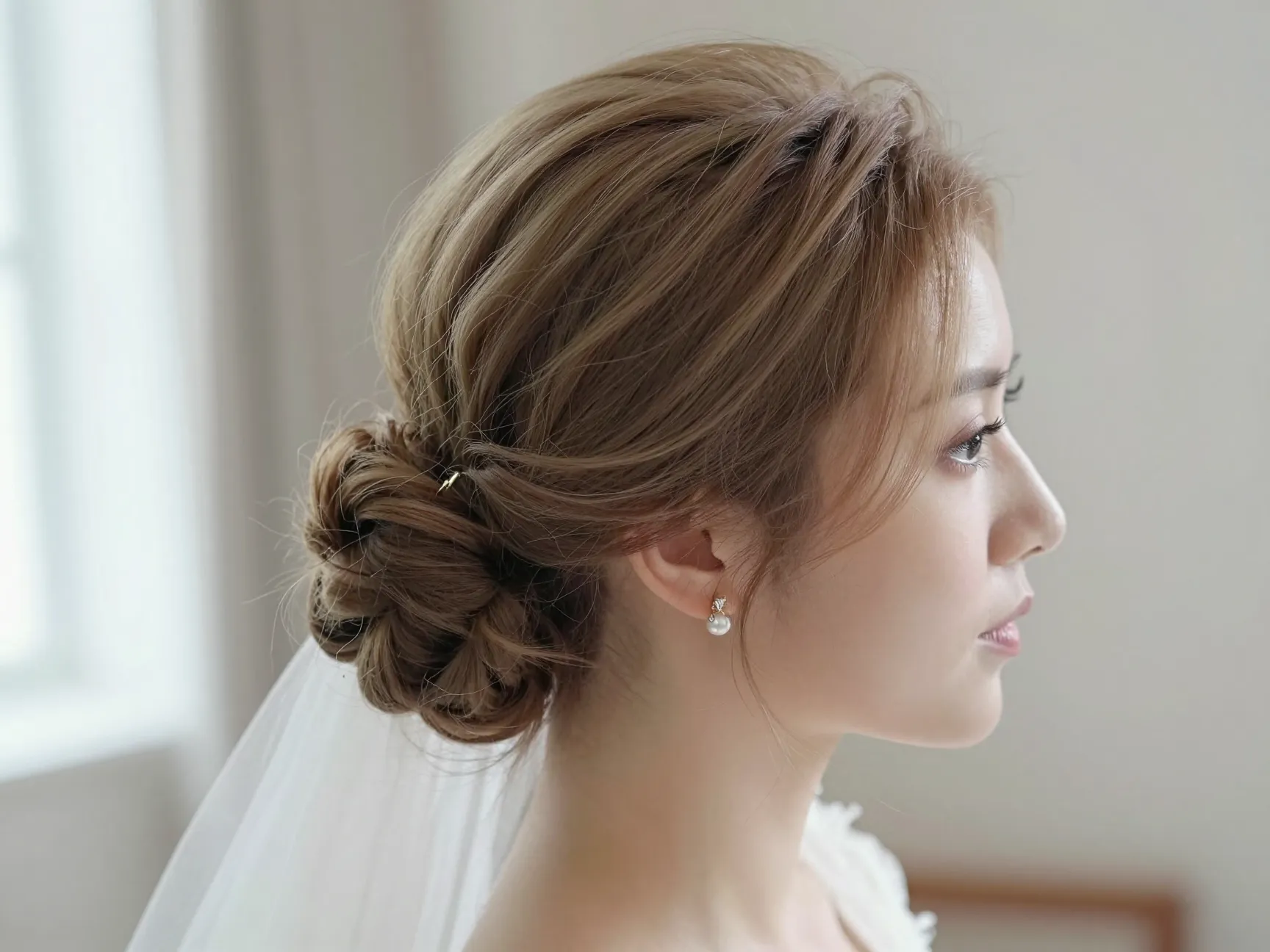Teased and pinned romantic updo with face framing tendrils