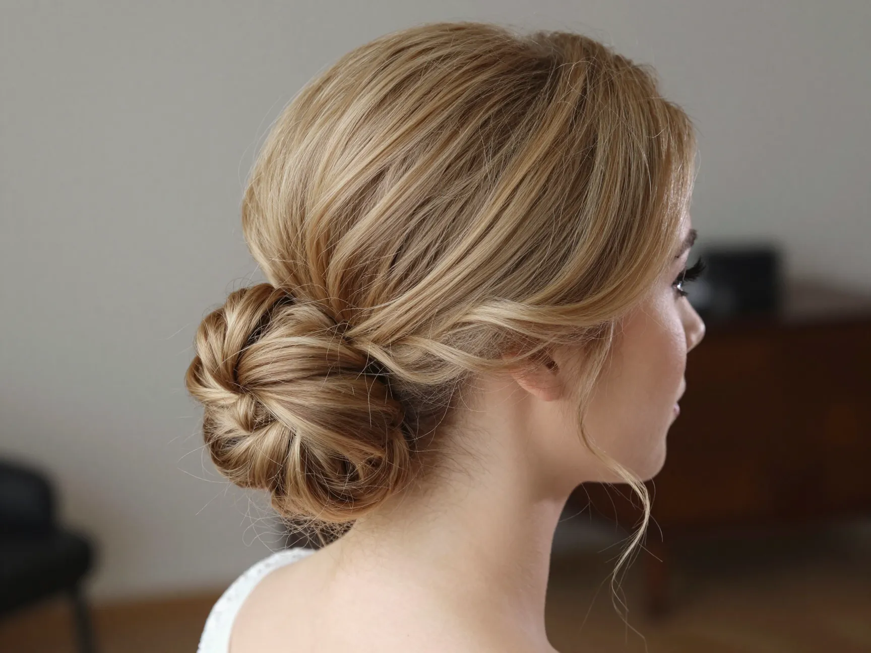 Bride showcasing voluminous classic chignon updo with integrated hair extensions