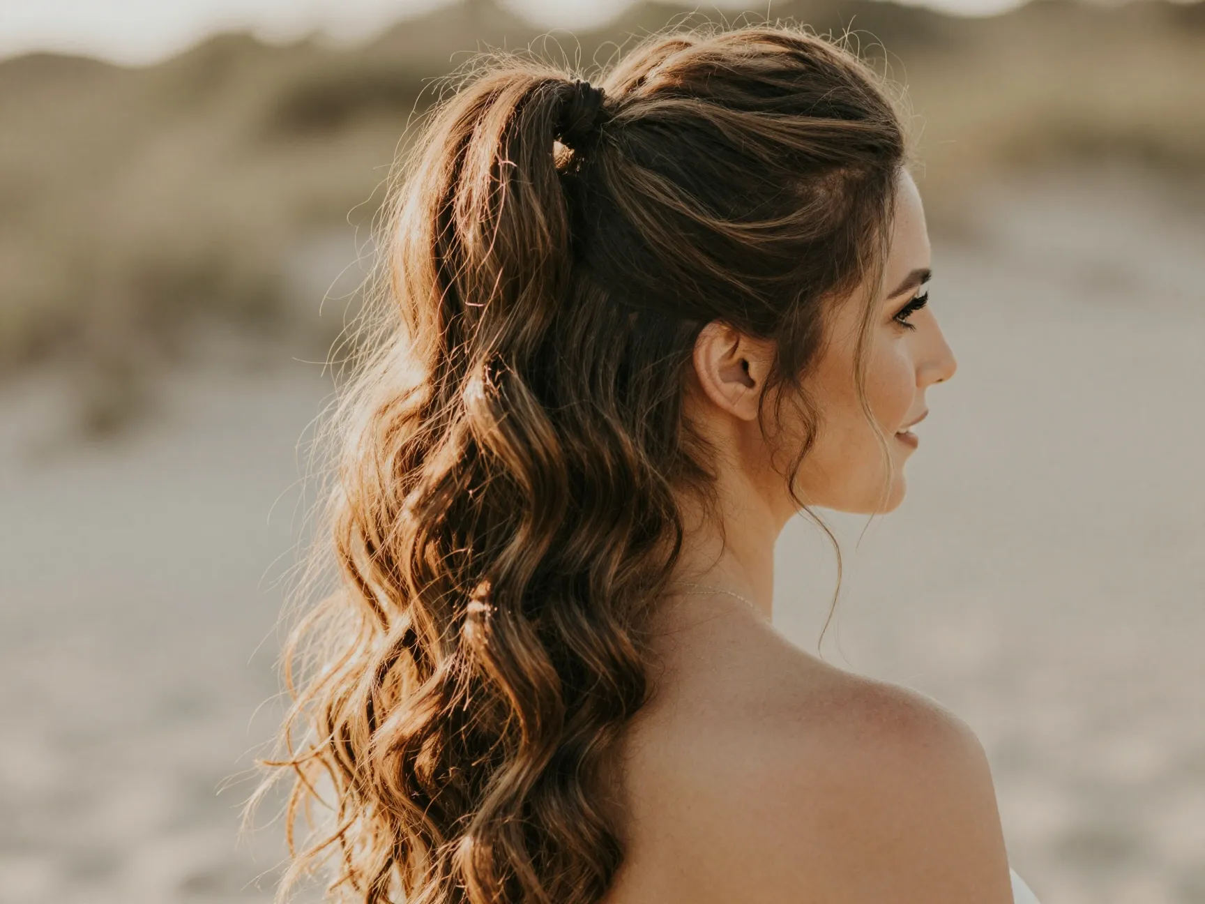 Wavy half pony hairstyle with voluminous crown and flowing texture