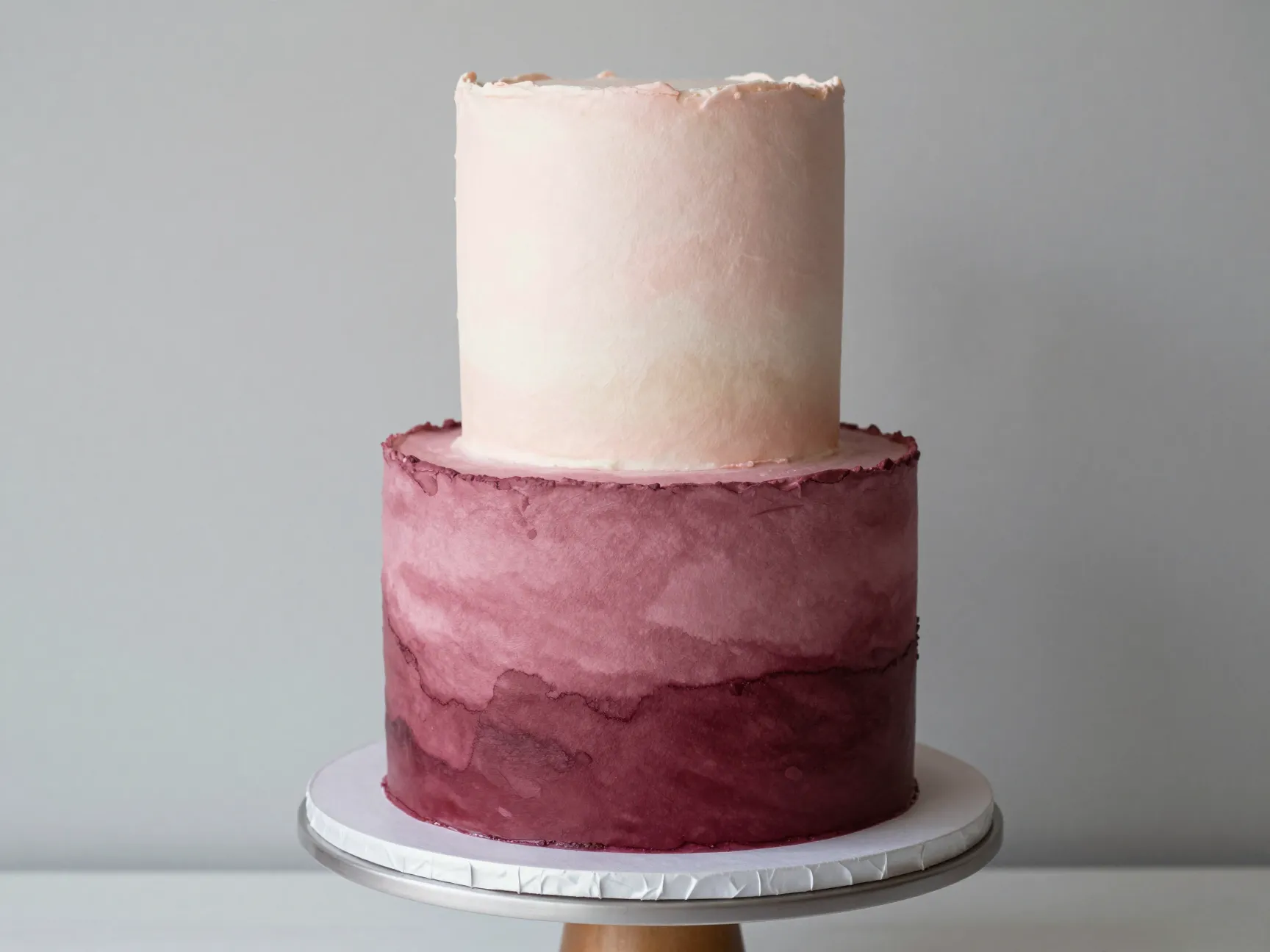 Watercolor ombre single tier cake with gradient from burgundy to blush