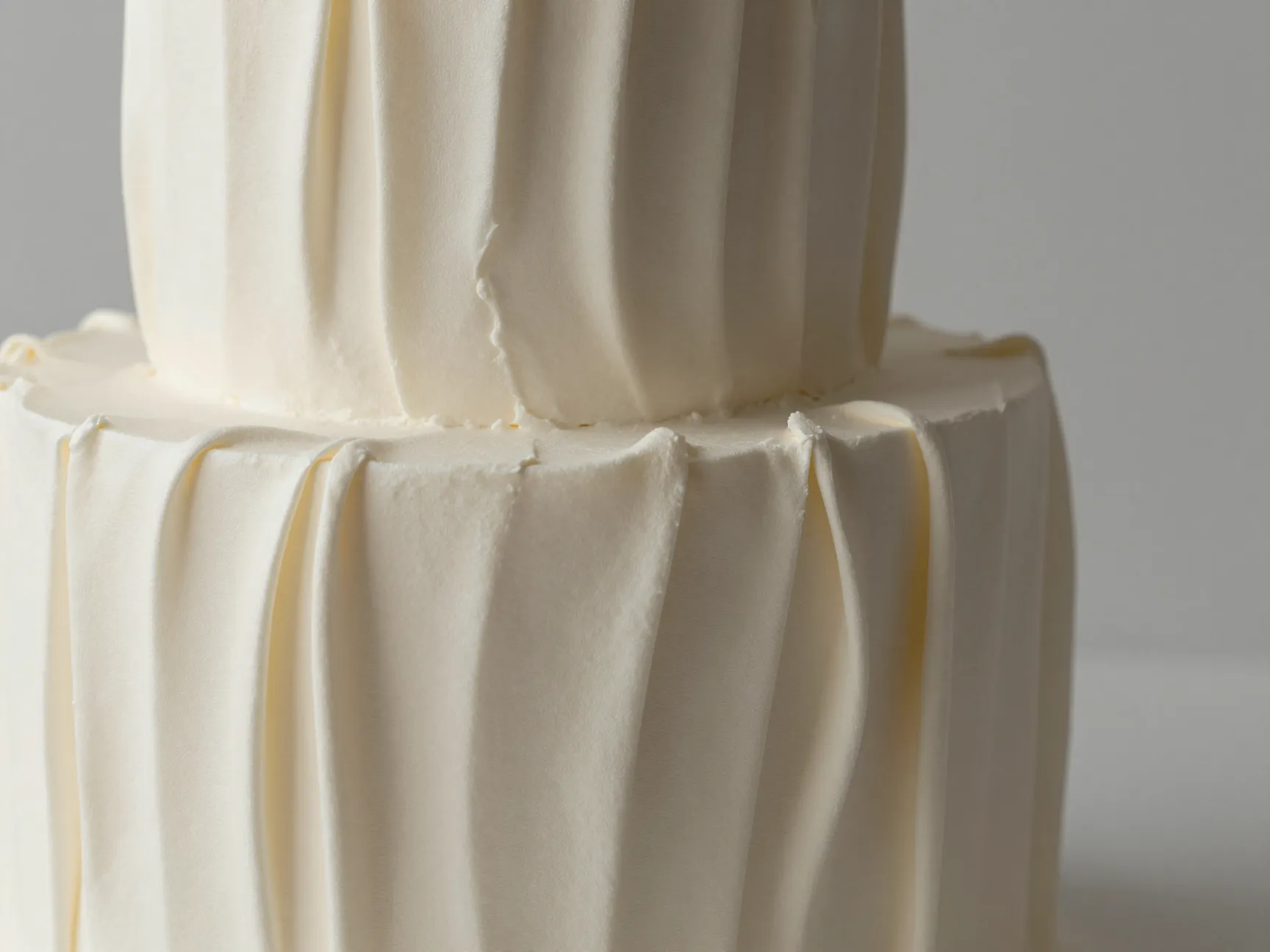 Textured pleated buttercream wedding cake mimicking draped fabric