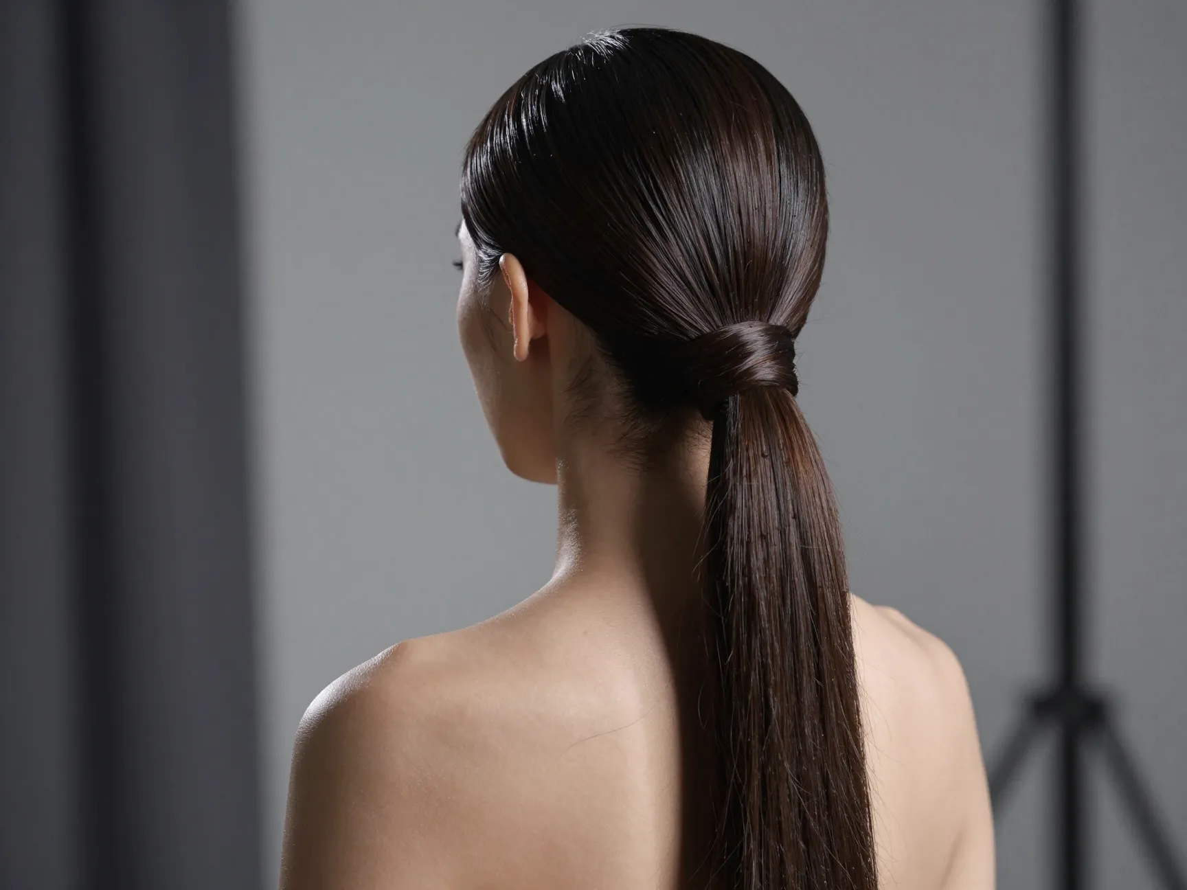 Sleek modern high ponytail with hair wrap and smooth finish