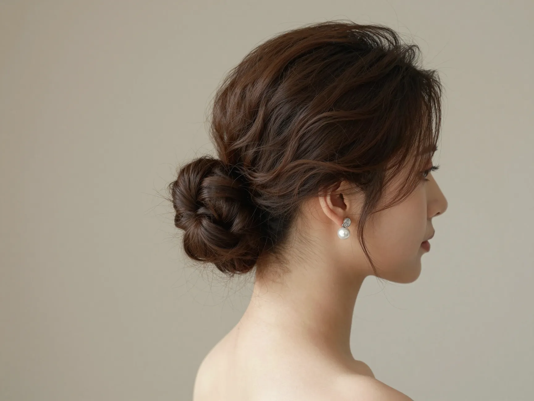 High softly swept updo creating volume and elongating the neck