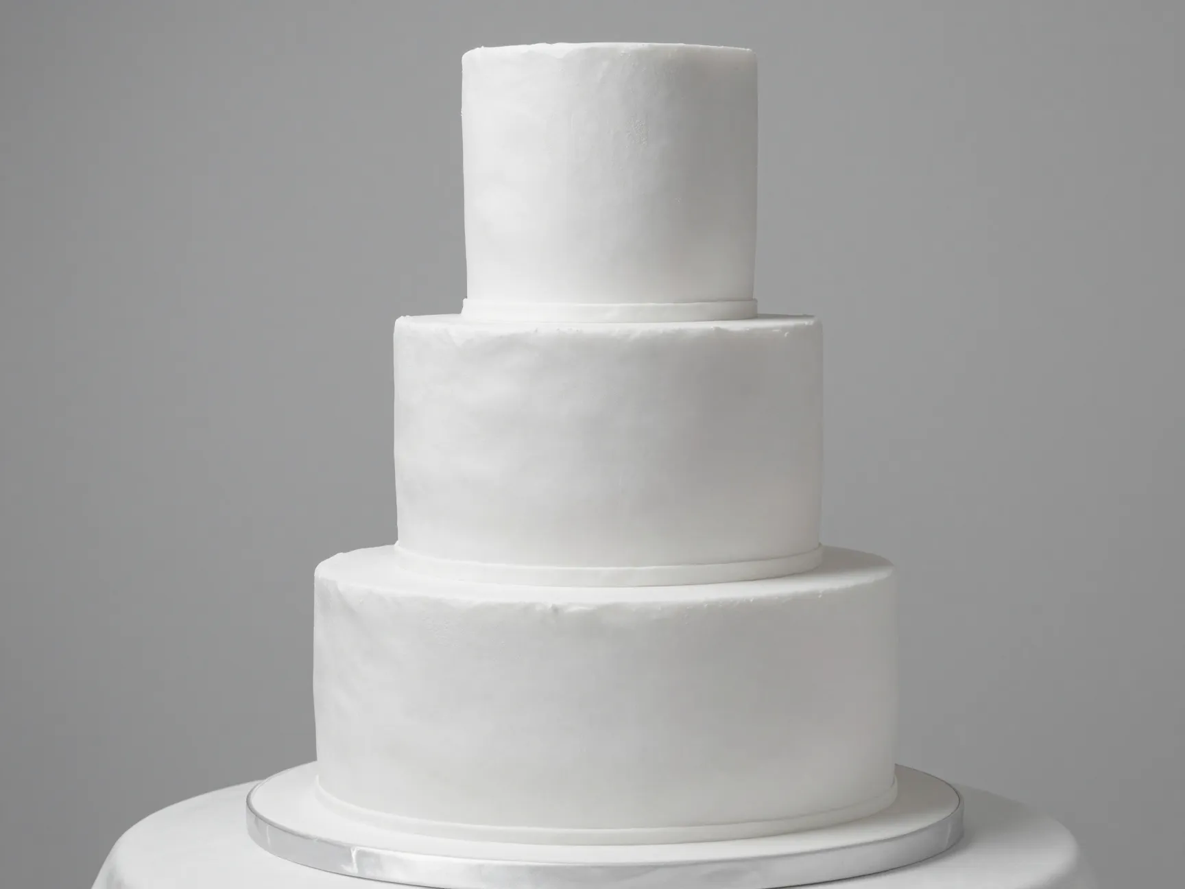 Monochrome minimalism textured white wedding cake tiers with mat satin finish
