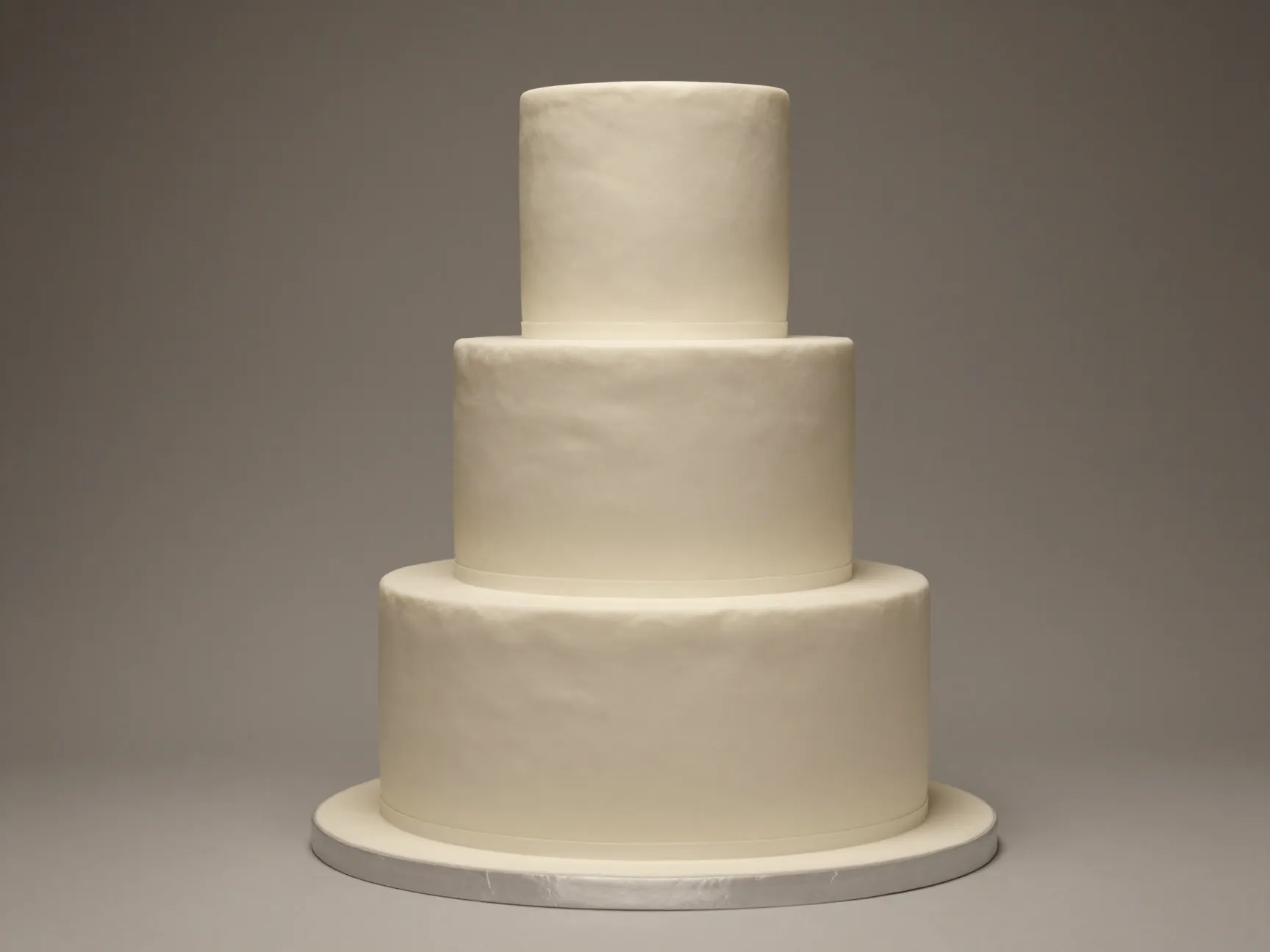 Elegant oval shaped tiered wedding cake with smooth matte finish