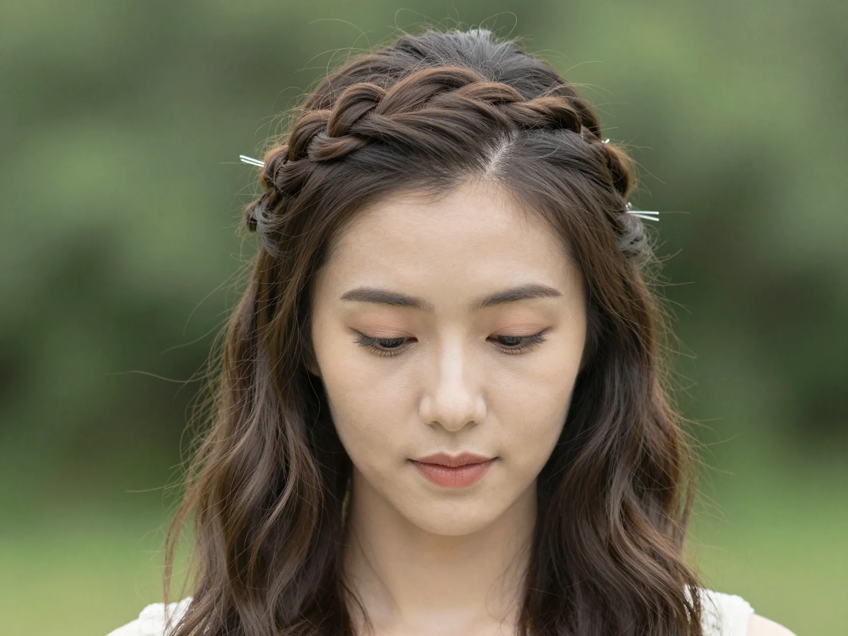 Half up half down hairstyle with braided crown framing face