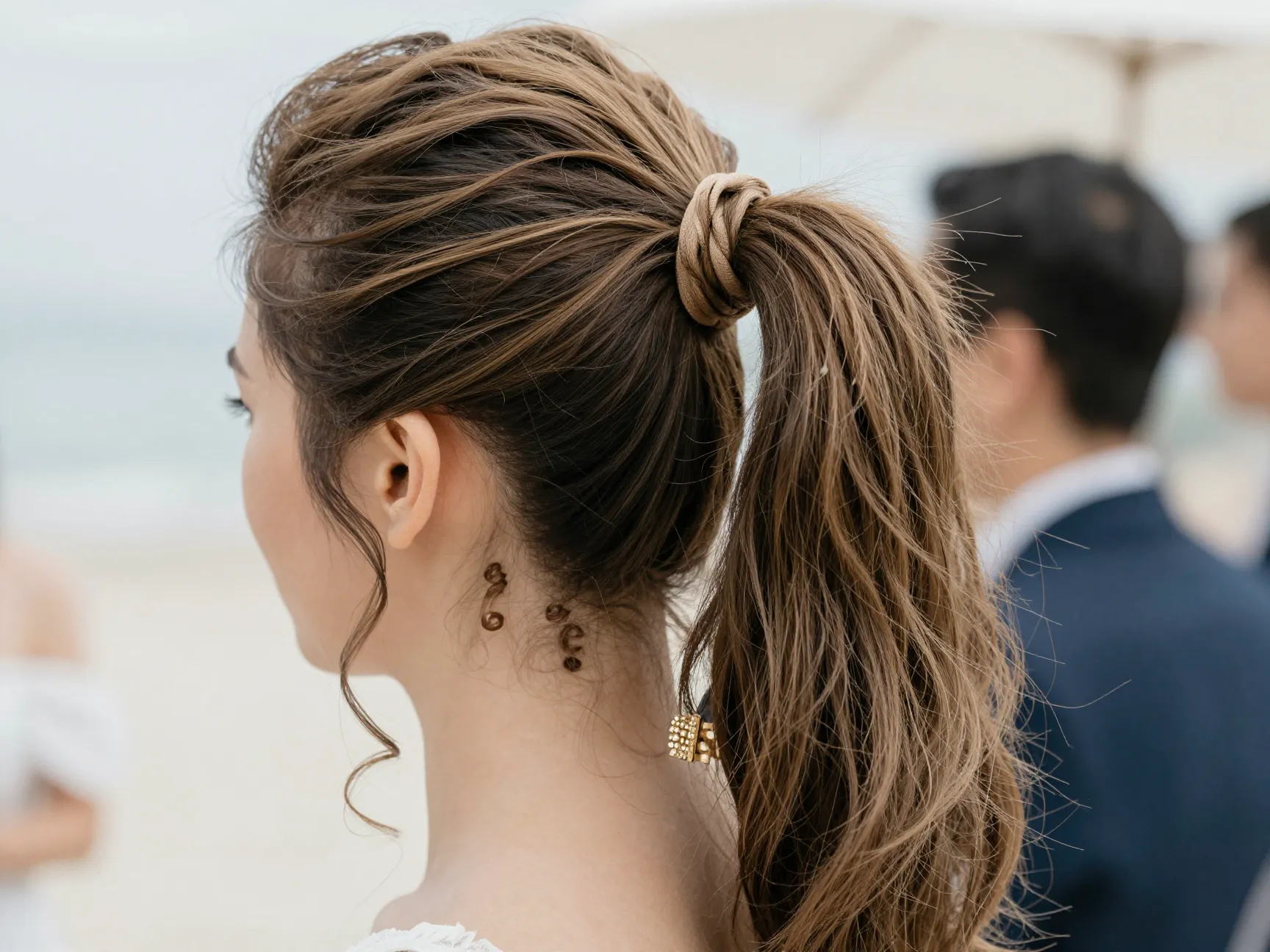 High textured ponytail with ribbon tie at festive destination wedding