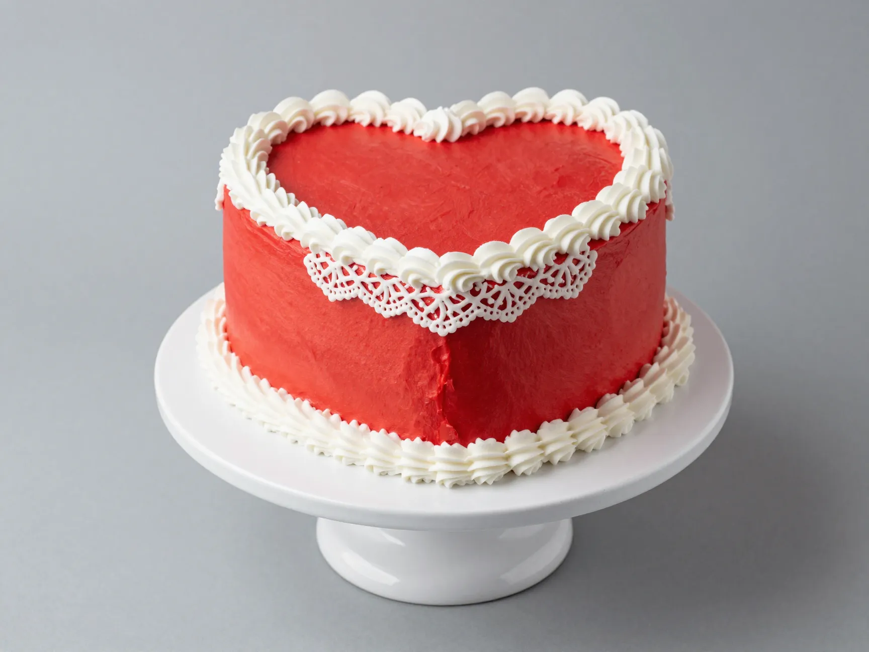 Classic red and white heart cake with bold fondant and lace piping