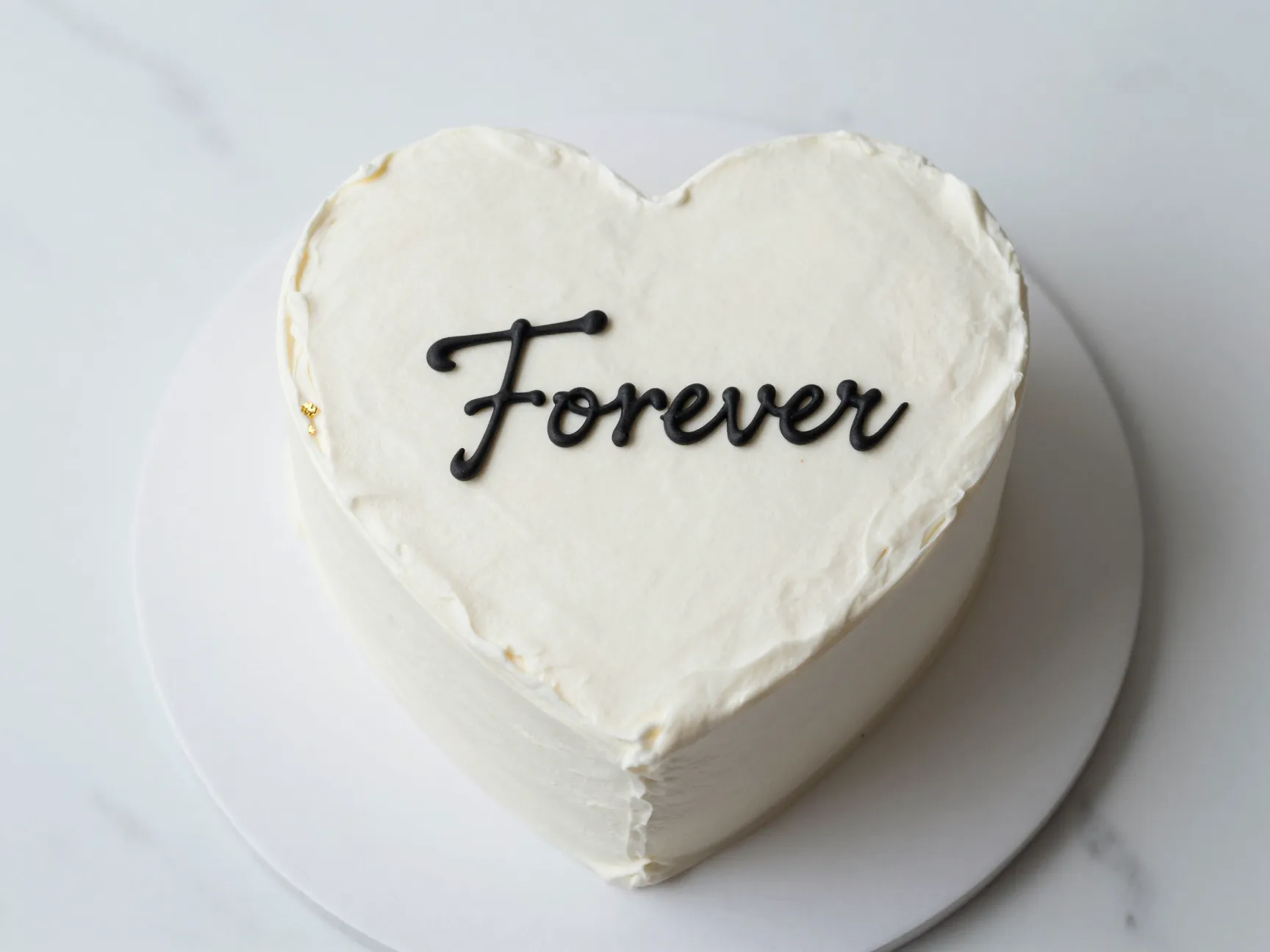 Minimalist elegant script heart cake with clean white fondant