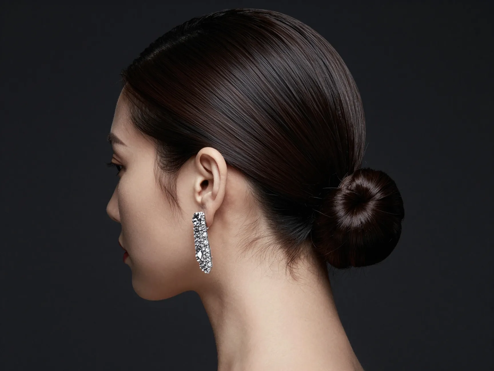 Woman with straight hair in minimalist sleek low bun