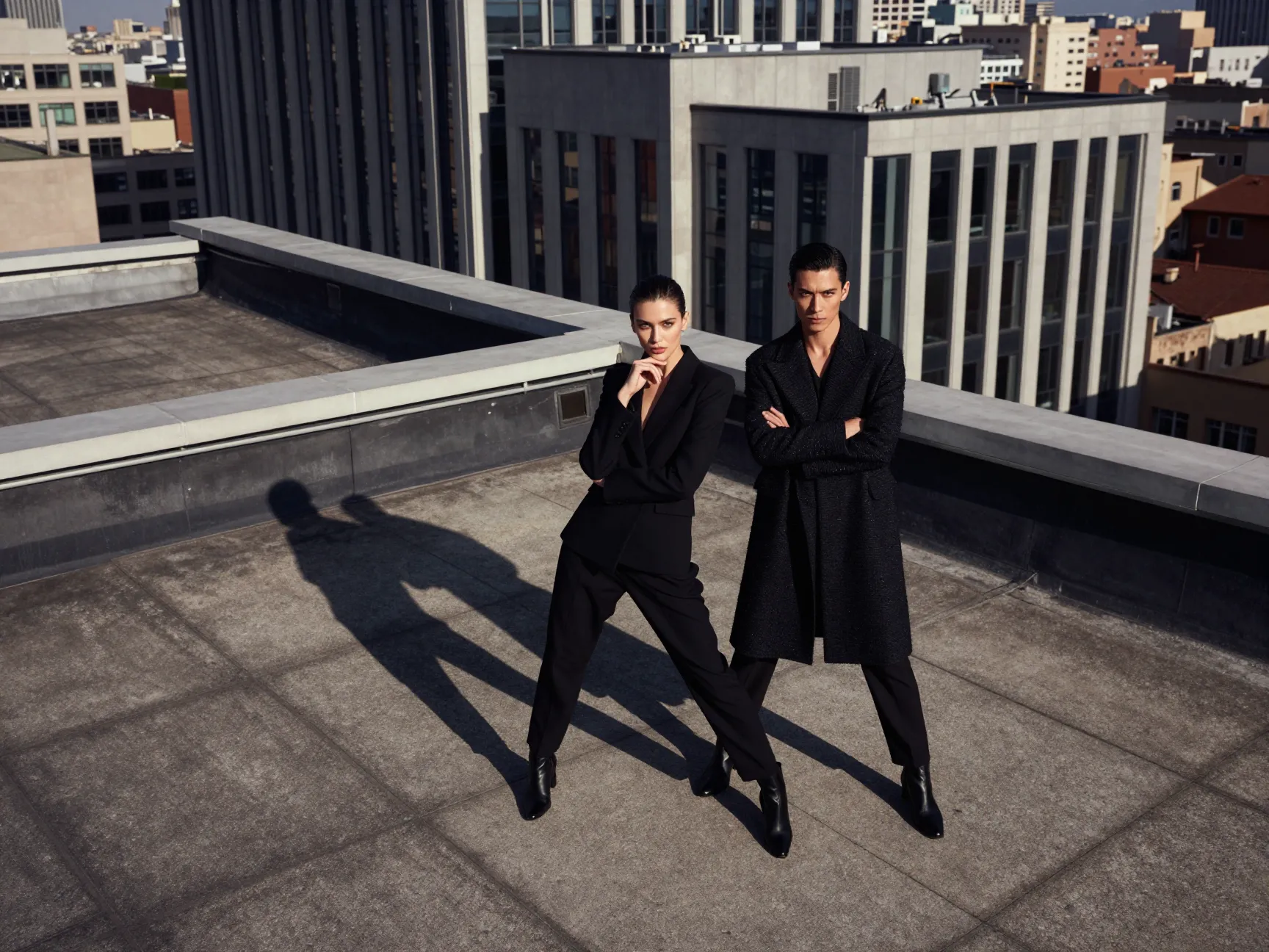 Fashion forward couple posing dramatically on urban rooftop