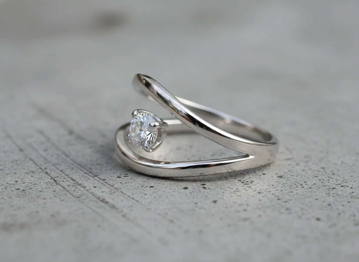Modern open wedding band with floating diamond and negative space