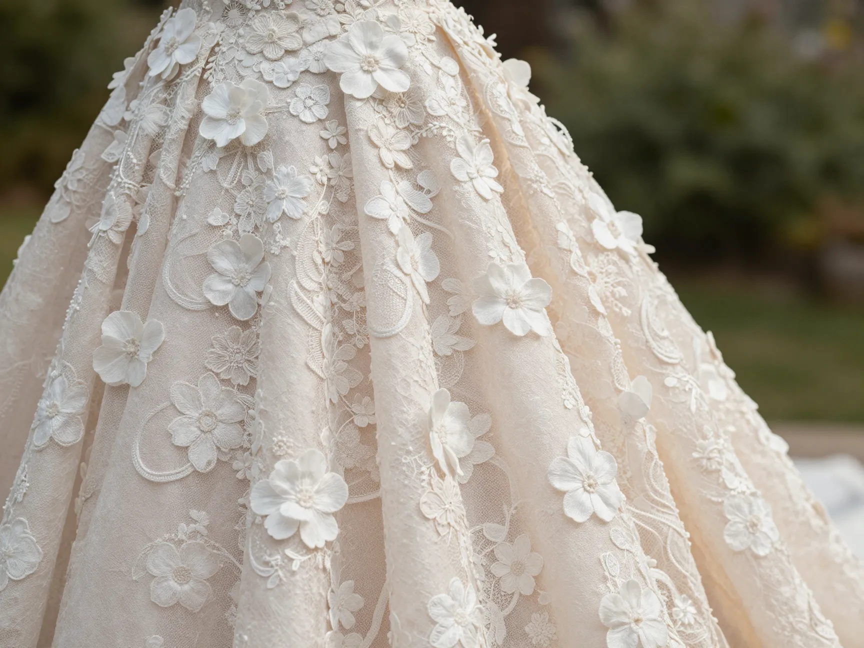 Artisanal lace applique gown with 3d florals in a garden