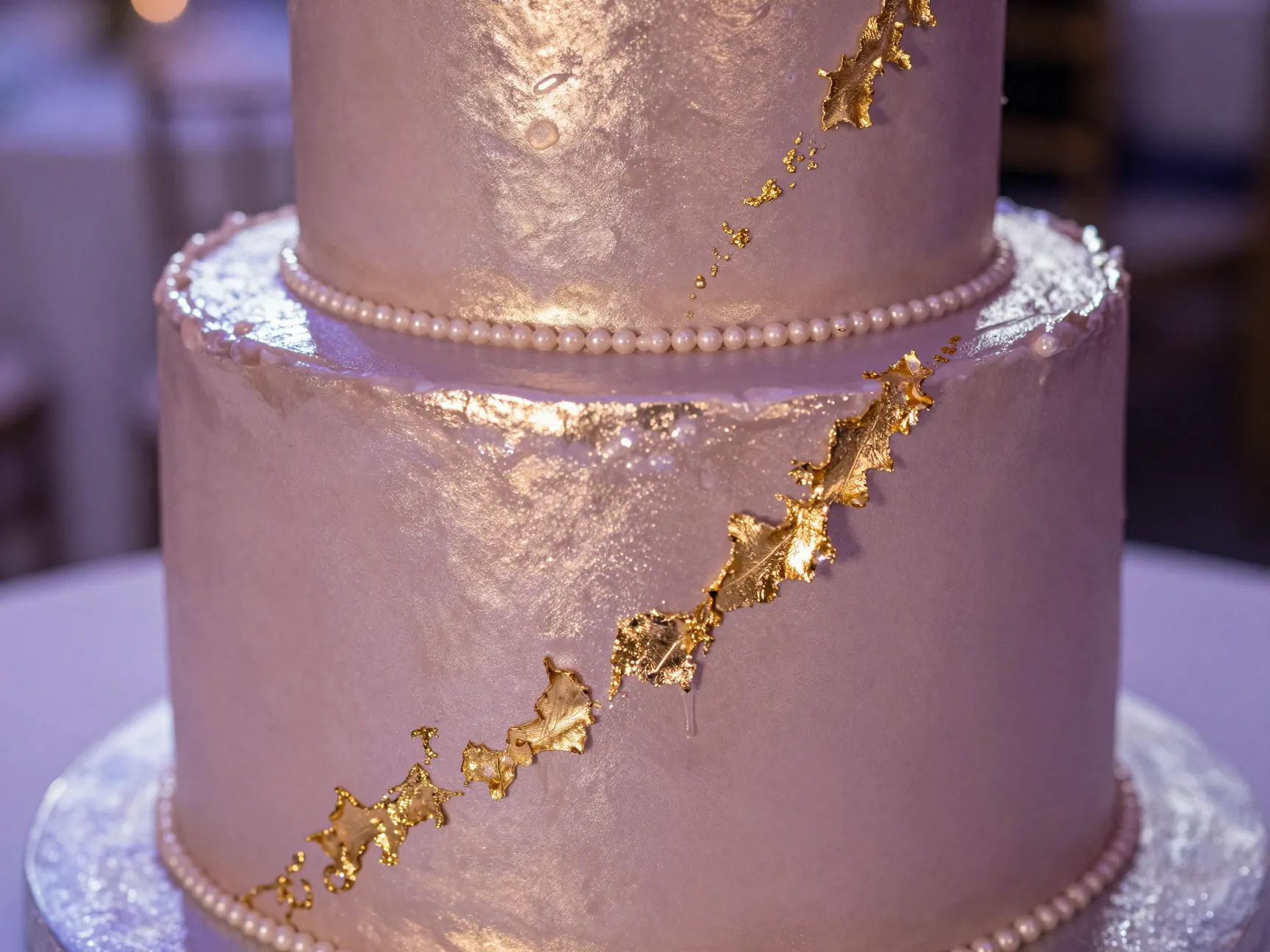 Metallic pearlescent cake with gold leaf and mauve sheen