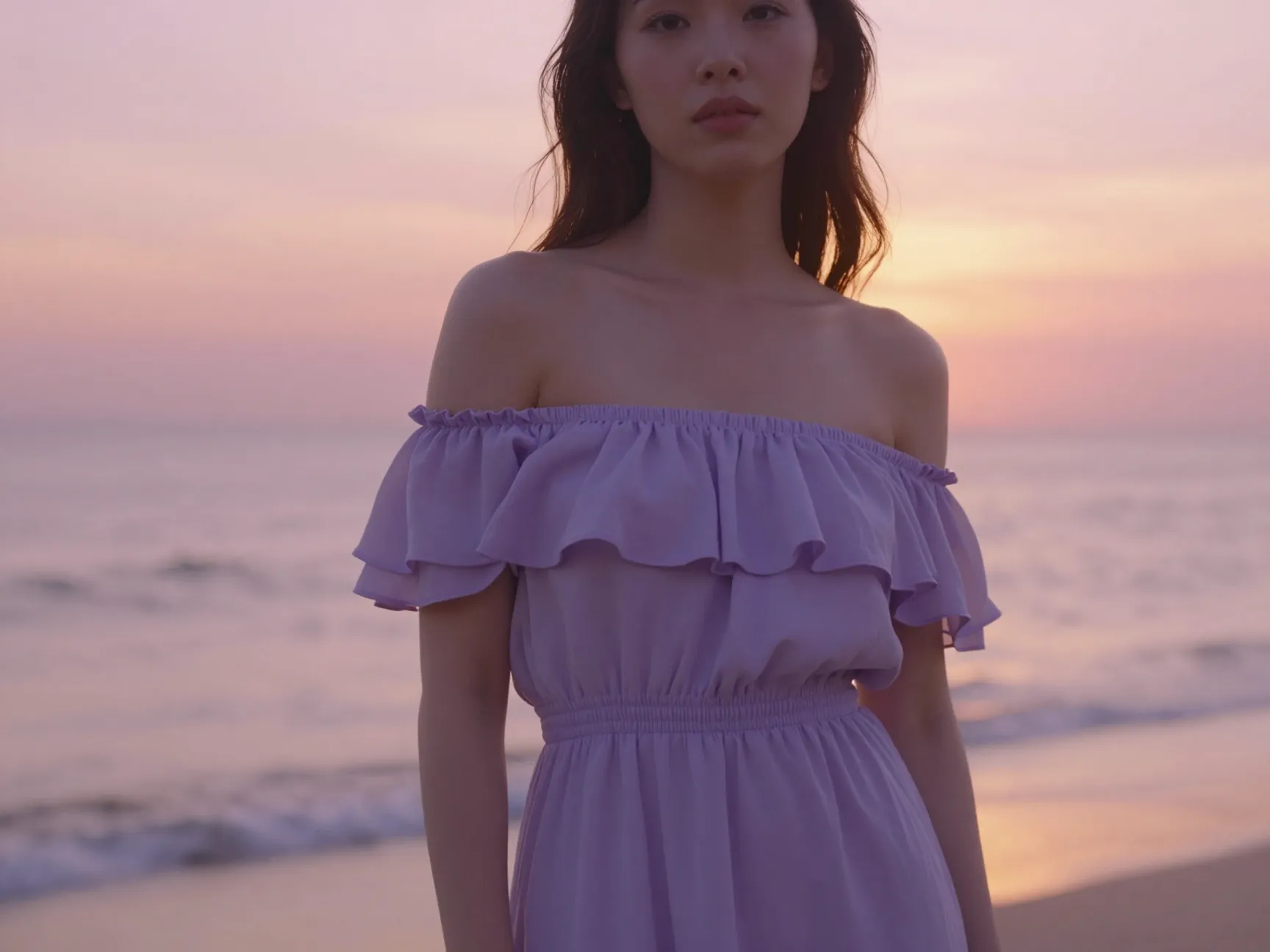 Off shoulder lavender dress on a beach during sunset