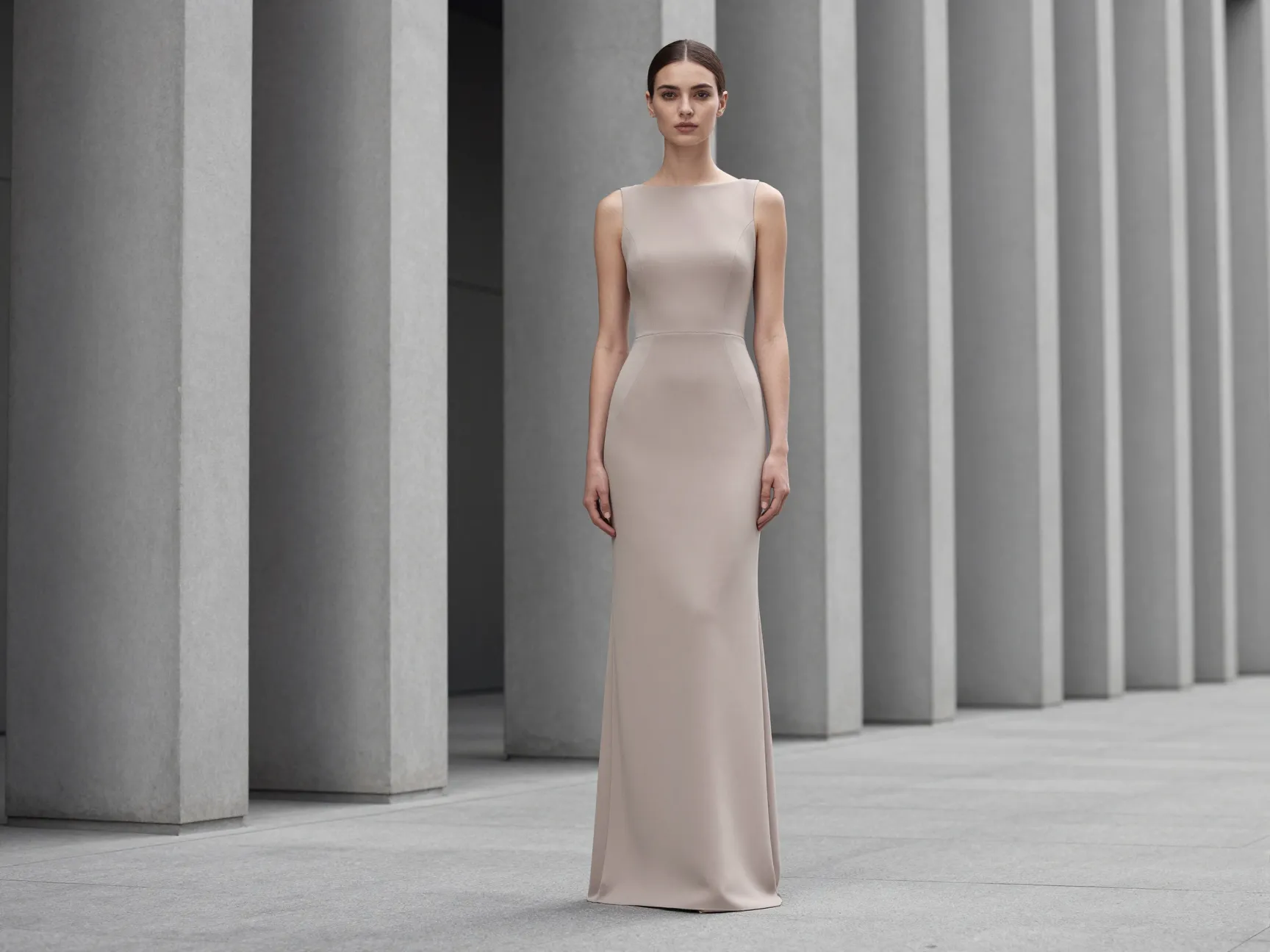 Elongating drop waist gown against modern architectural lines