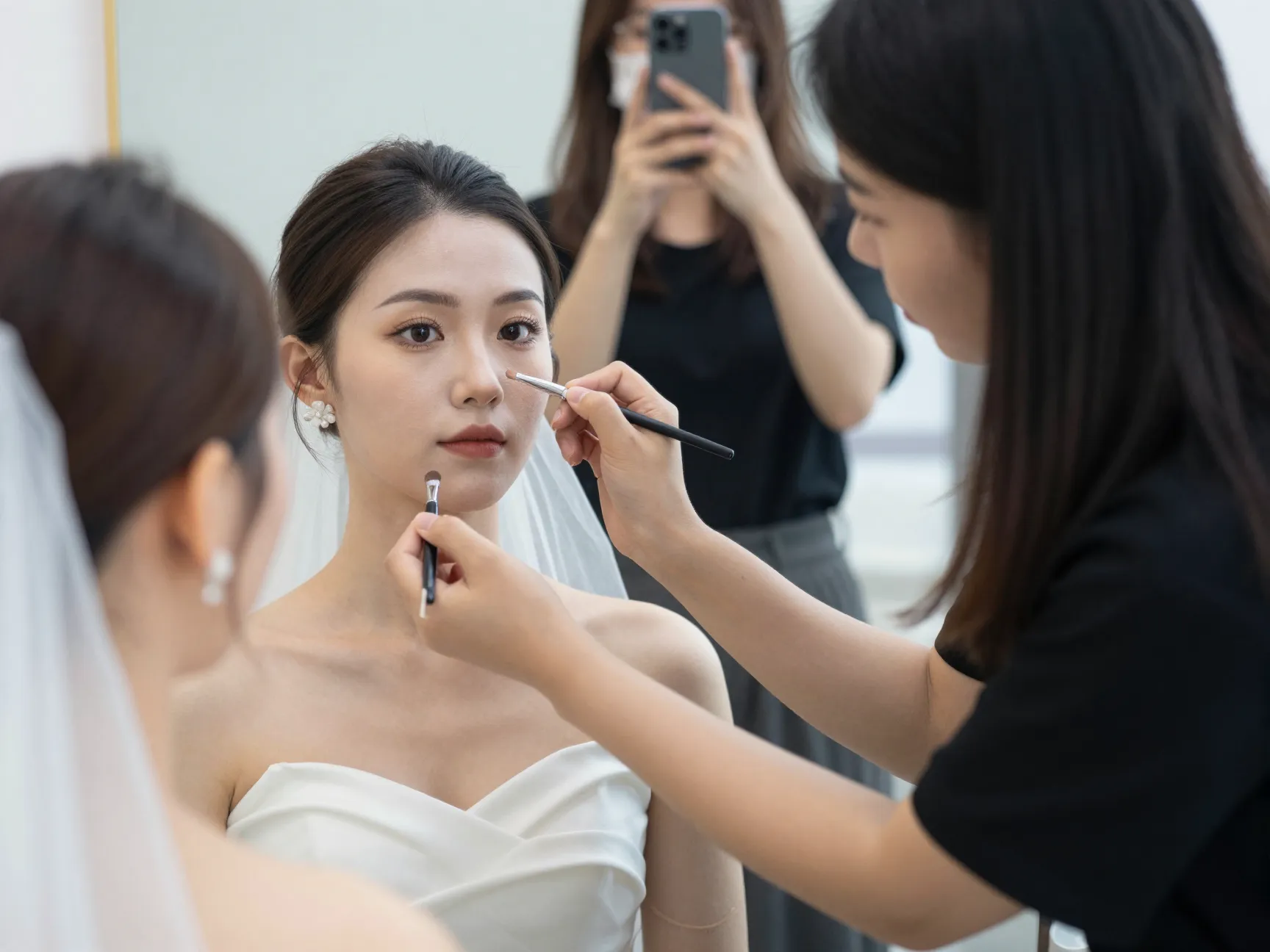 Bride at makeup trial session with artist taking photos
