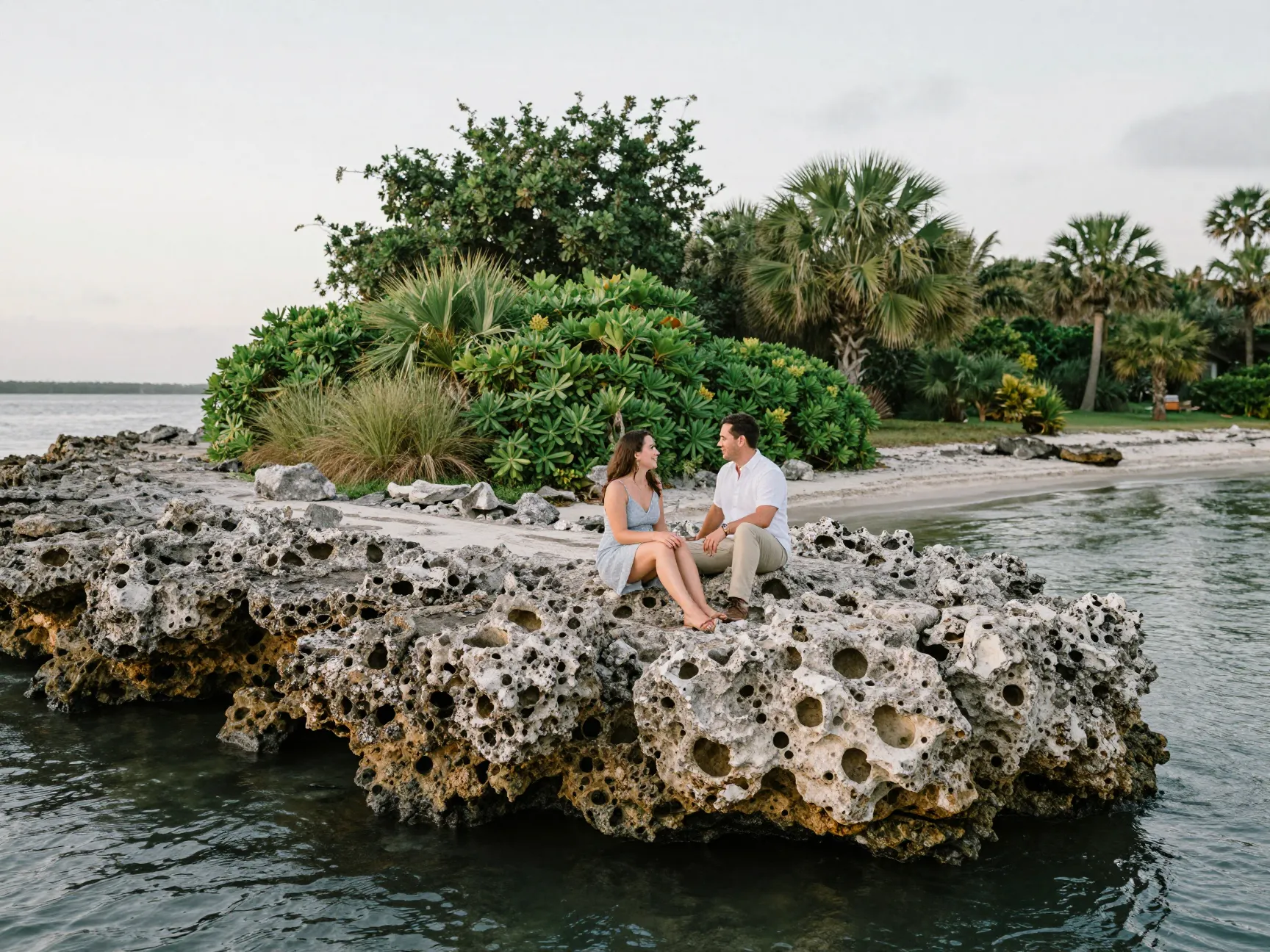 Coastal garden serenity with couple on coquina rocks at washington oaks
