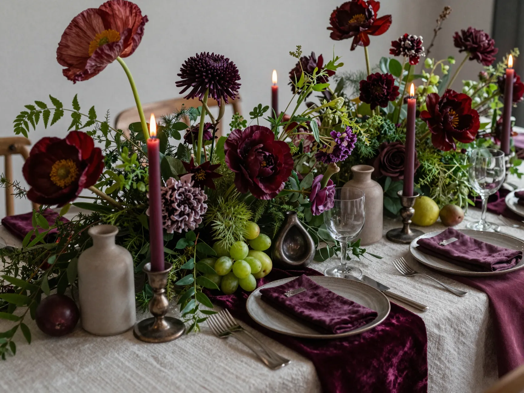 Maximalist tablescape with layered florals sculptural candles and textures