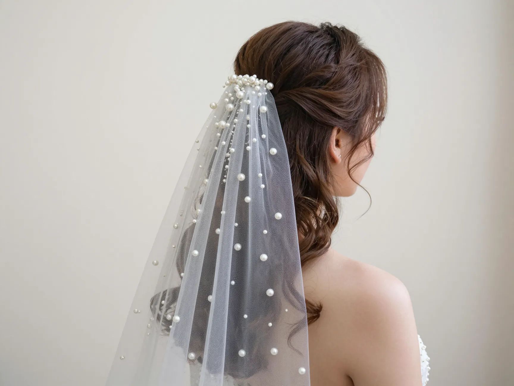 Half up half down soft waves with pearl veil