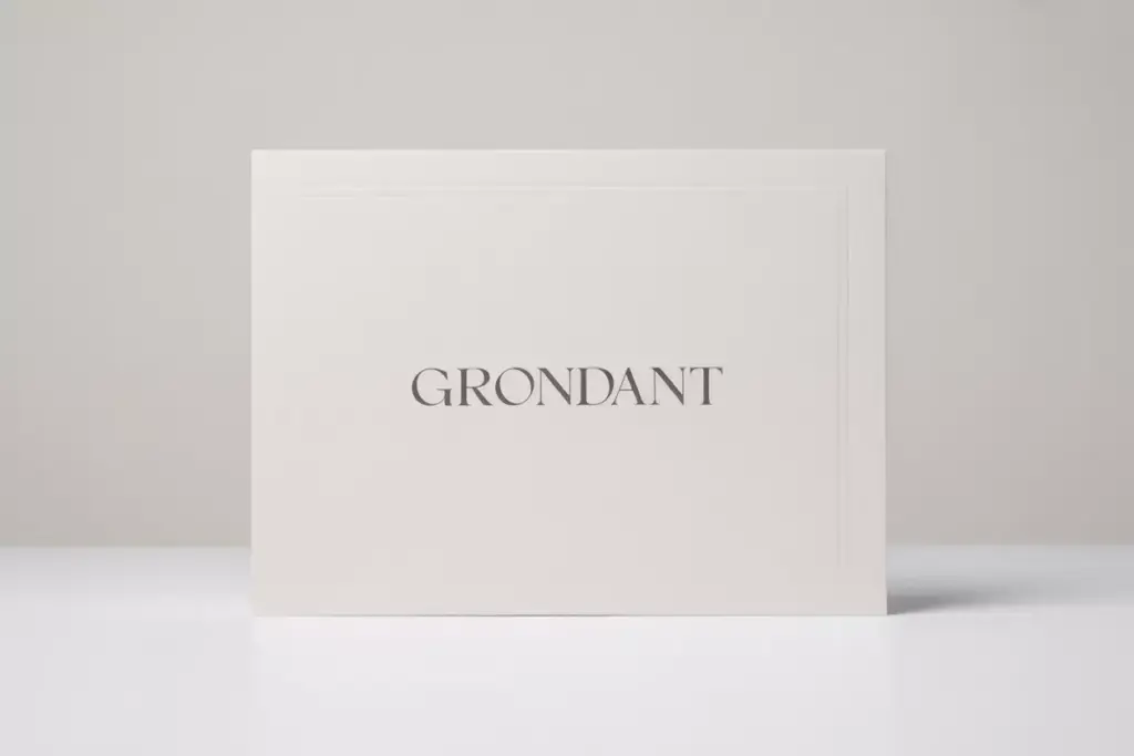 A white card with the word GRONDANT printed in elegant, uppercase letters, set against a plain background.