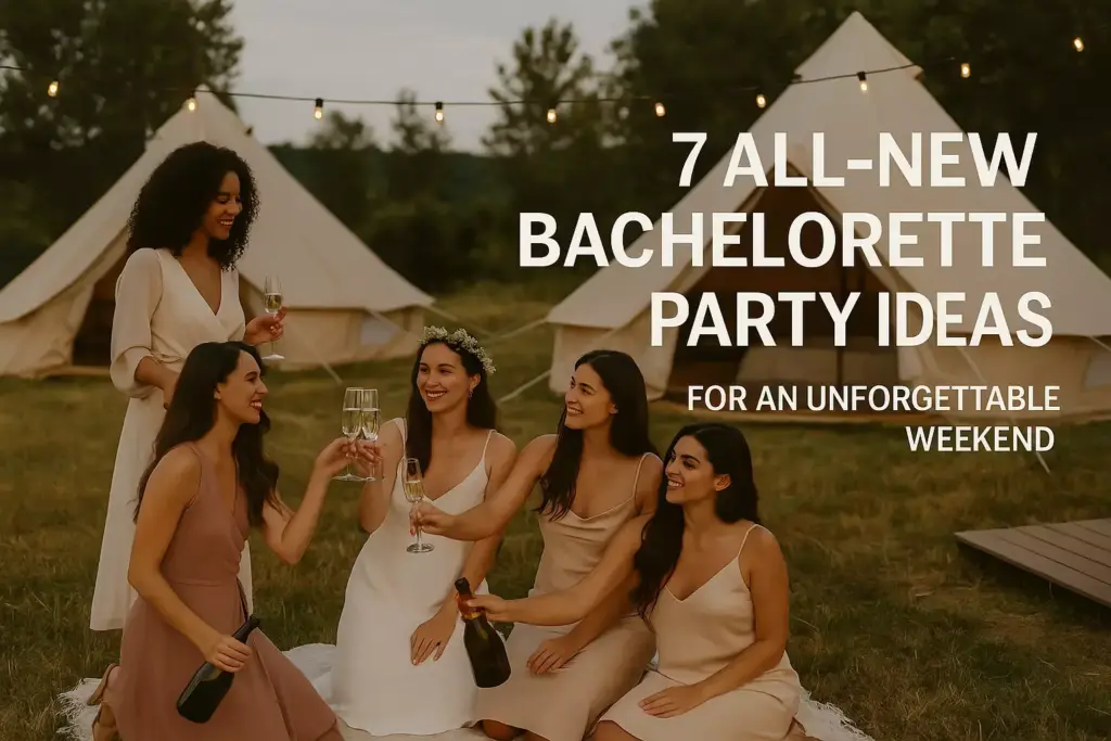 Five women in dresses celebrate with champagne outdoors near tents, under string lights, at sunset.