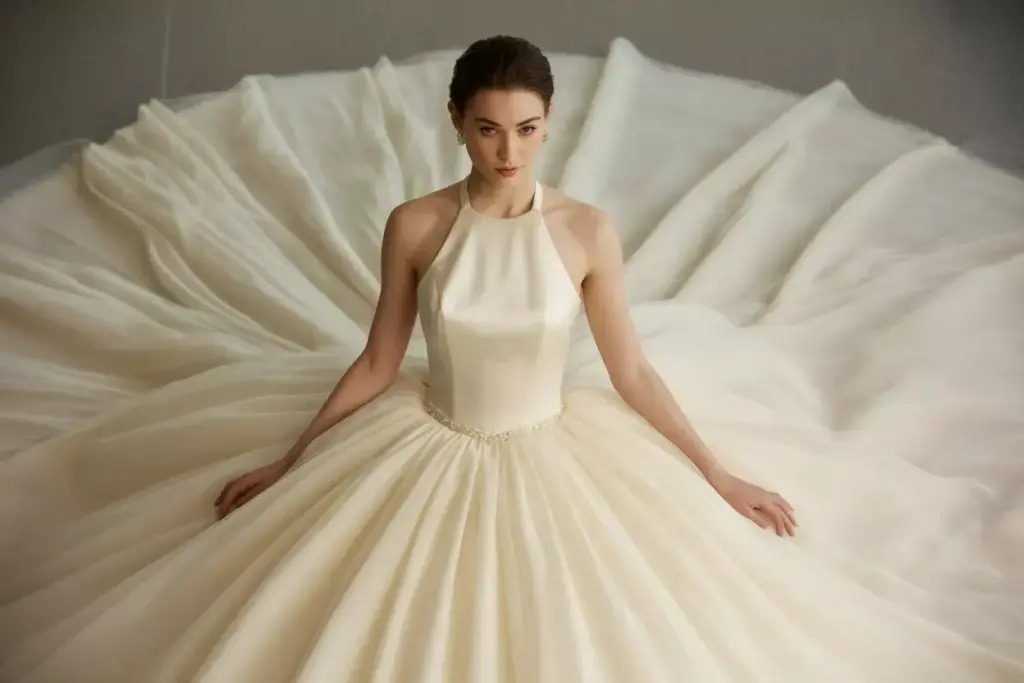 Ivory halter gown with beaded bodice and tulle skirt trail