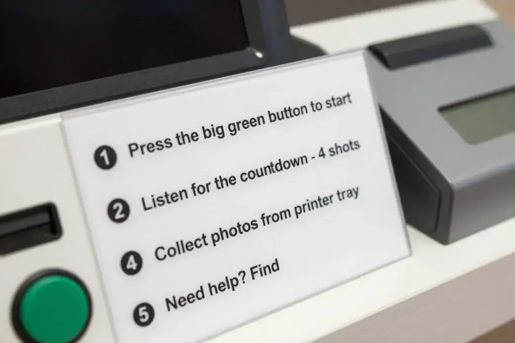 Detailed technical instruction sign next to photo booth control panel