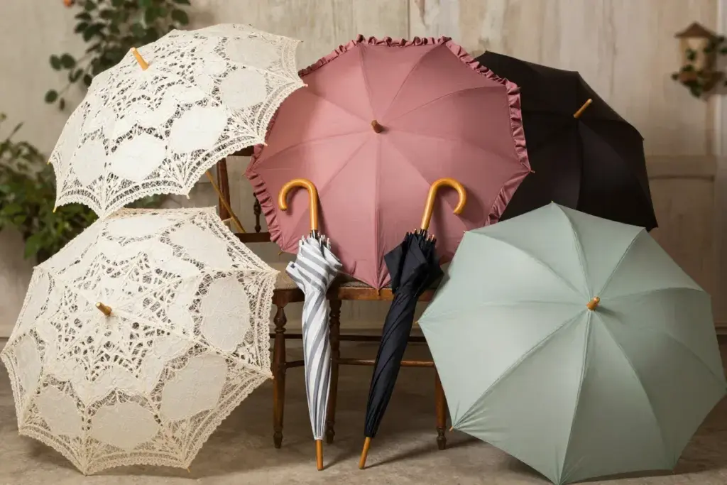 Group of lace and solid color parasols with vintage umbrellas