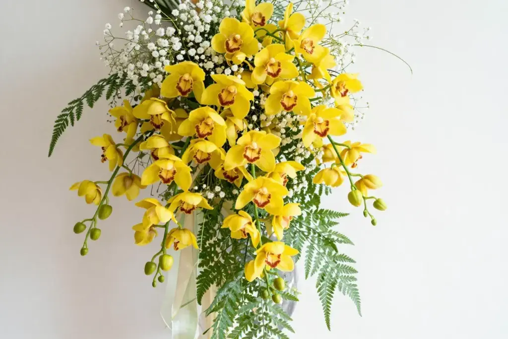 Yellow oncidium dancing lady orchid cascade with greenery