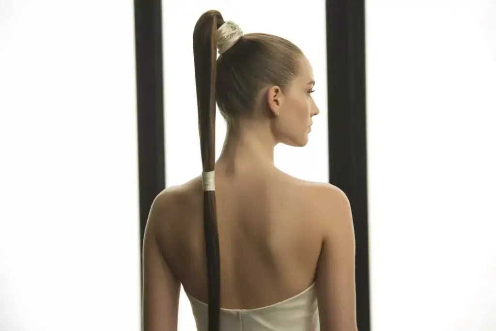 Sleek high polished ponytail with shine modern strapless dress silhouette