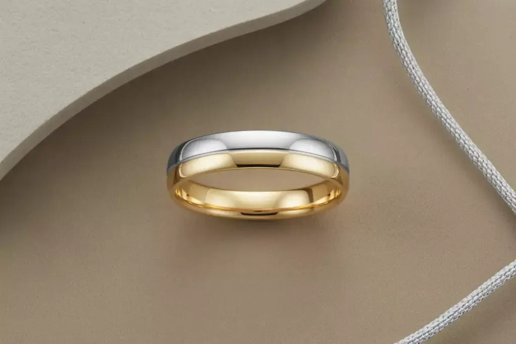 Two tone bi metal band platinum and gold flat lay