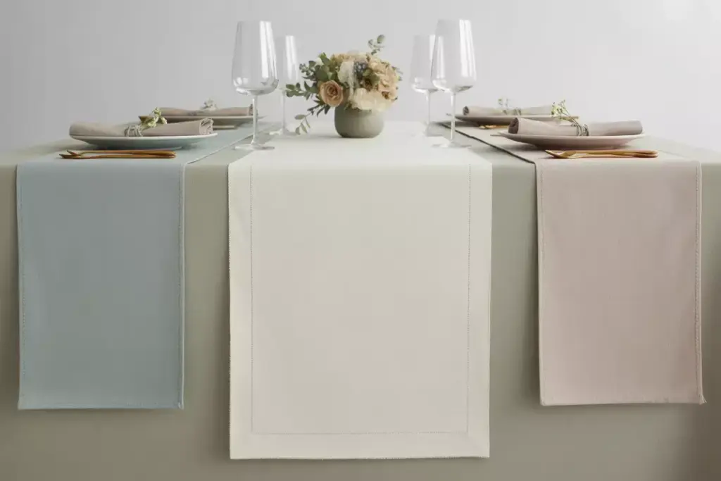 Elegant solid color cotton table runner with linen napkins on formal dining table